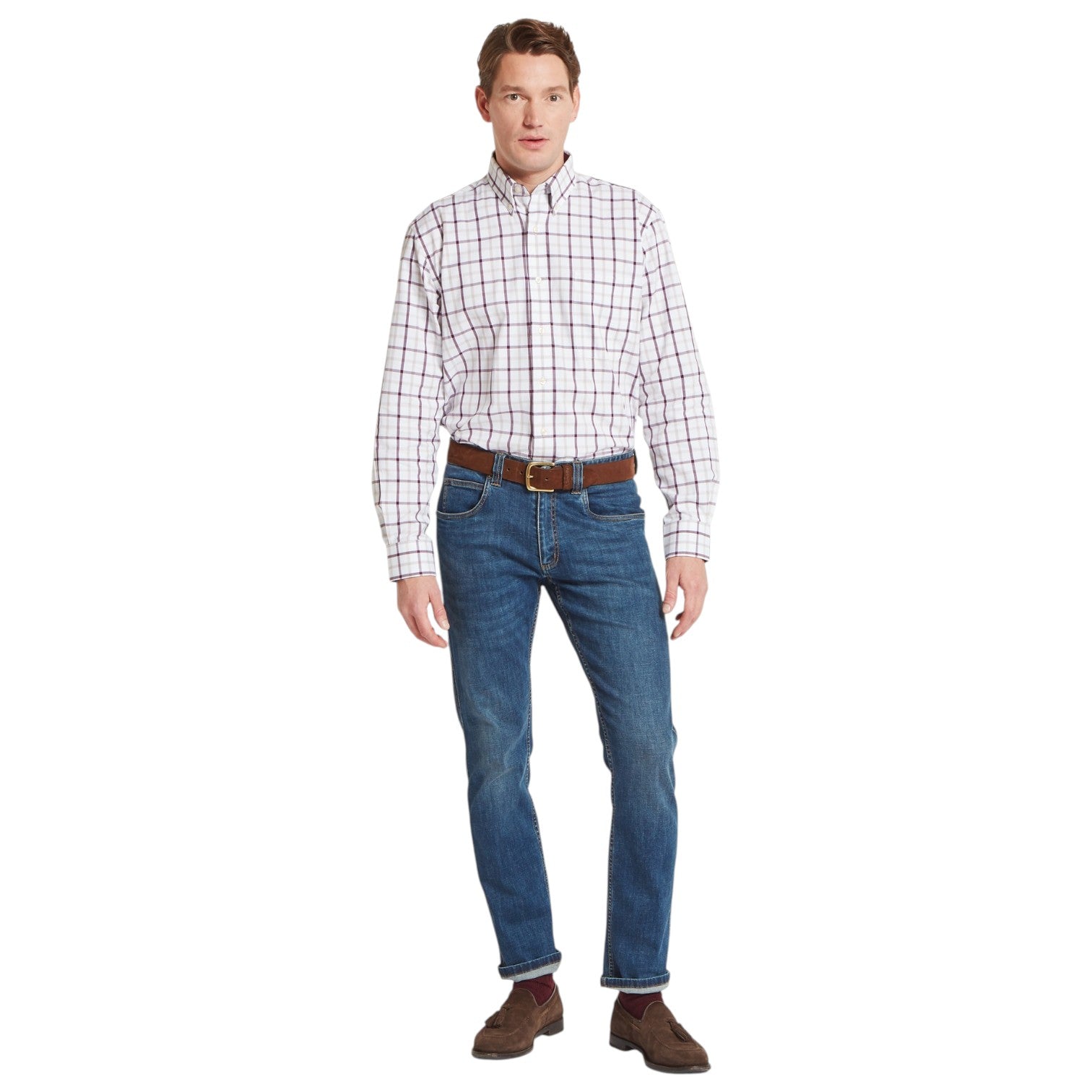 Man wearing a plaid shirt, jeans, and brown shoes on a white background