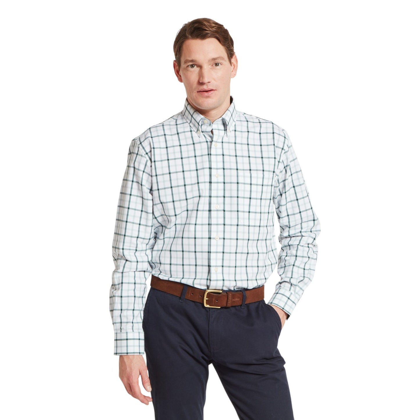 Man wearing a plaid shirt and dark pants on a white background