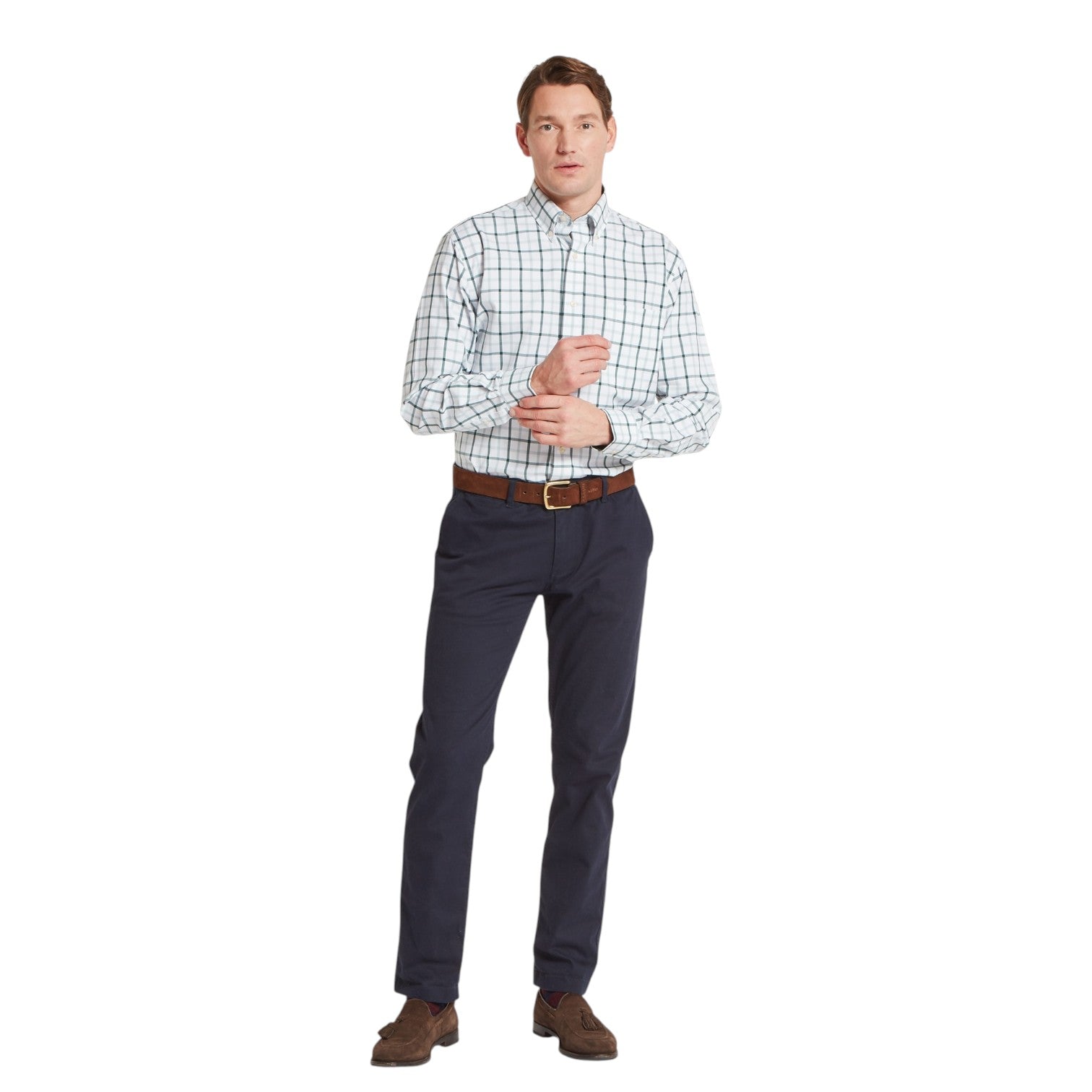 Man wearing a checkered shirt and dark pants on a white background