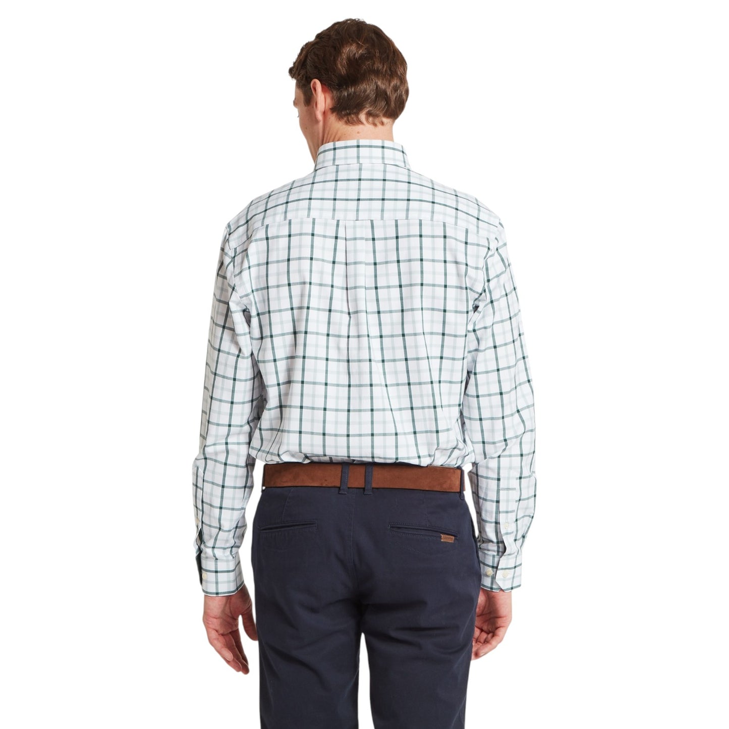 Man wearing a plaid shirt and navy pants on a white background