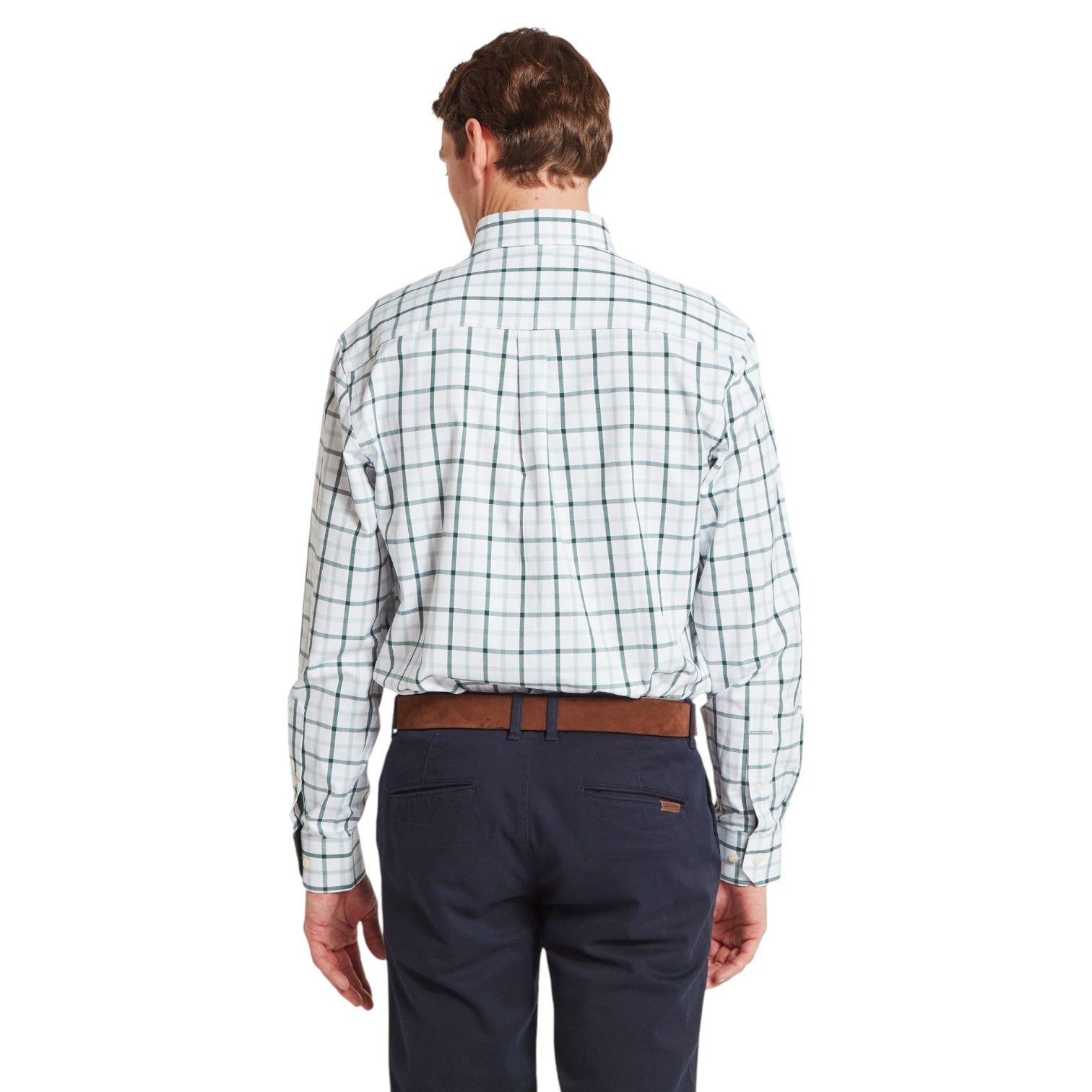 Man wearing a plaid shirt and navy pants on a white background