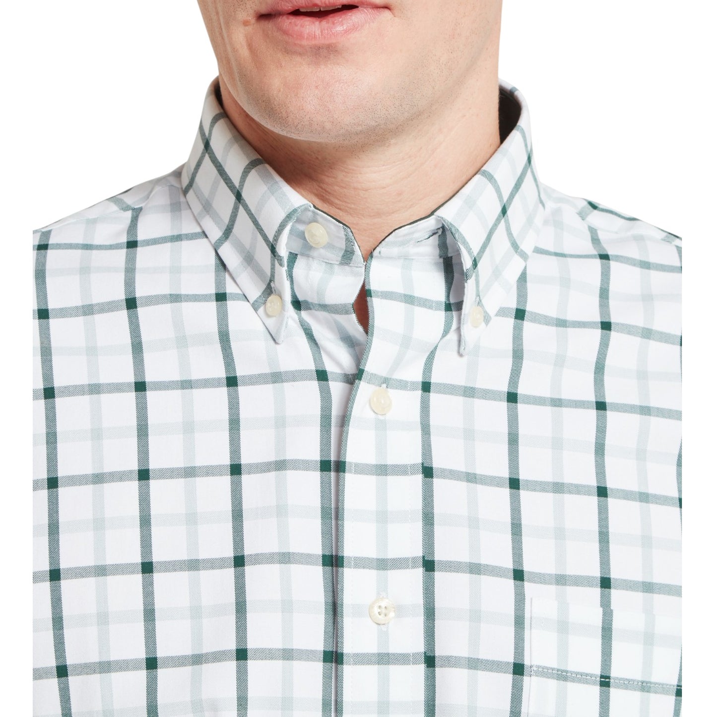 Green and white checkered shirt worn by a person on a white background