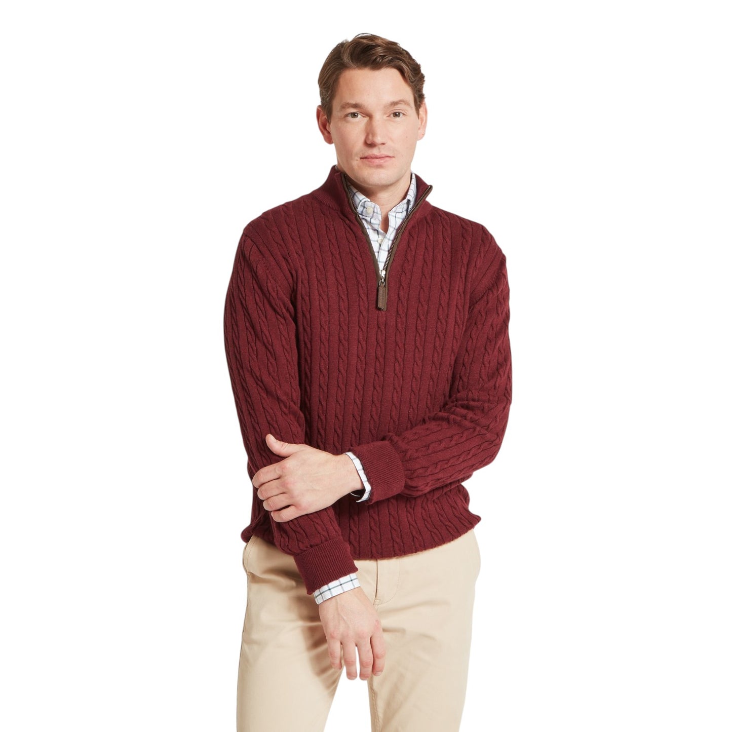Man wearing a maroon cable knit sweater with a white background