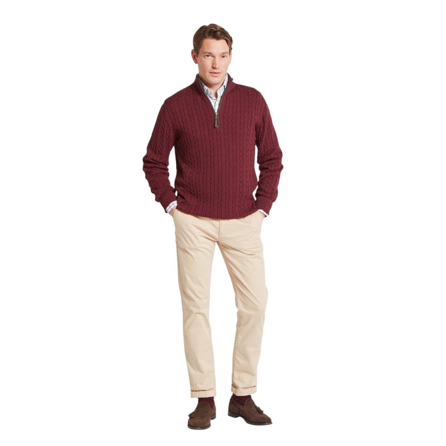 Man wearing a maroon sweater and beige pants on a white background