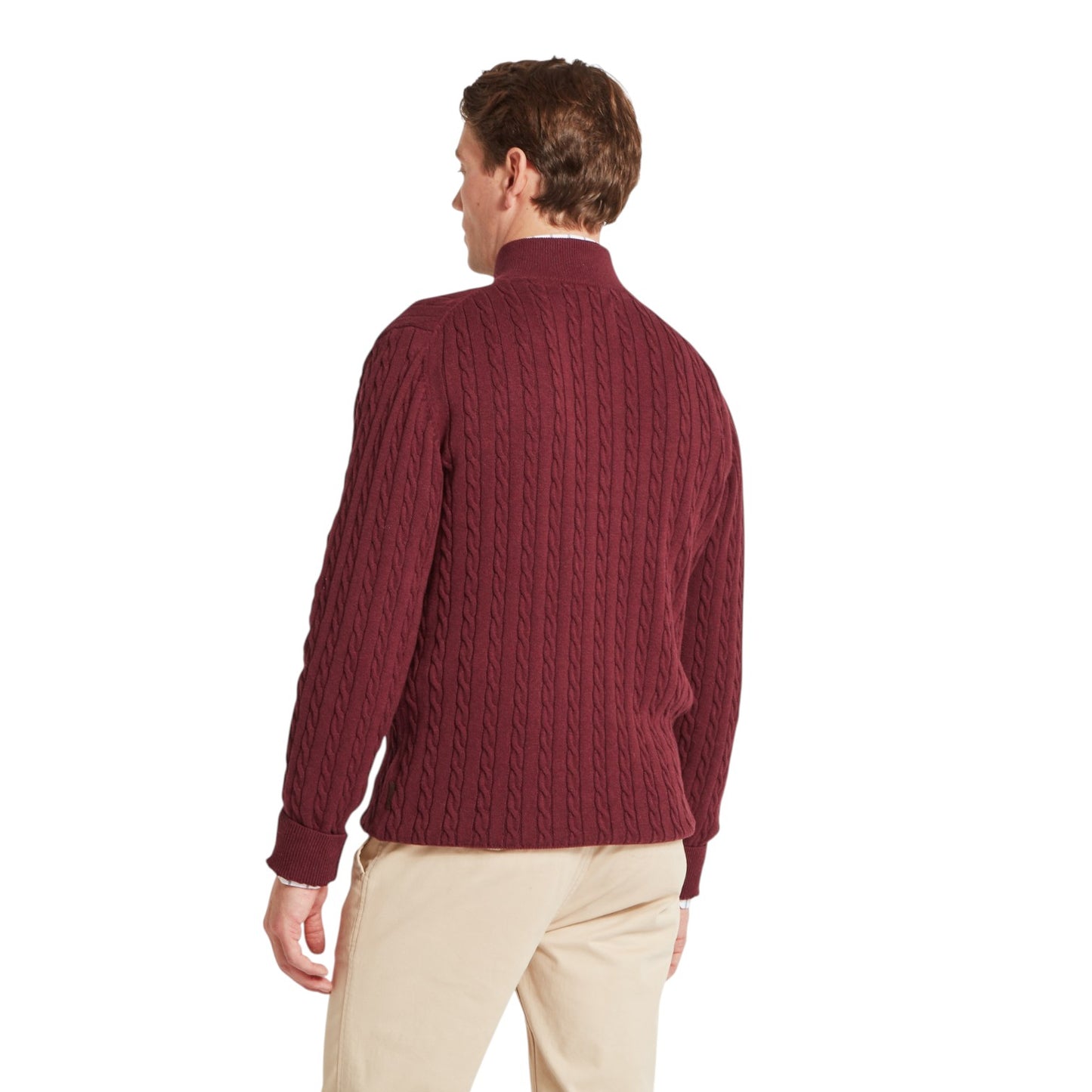 Man wearing a maroon cable knit sweater on a white background