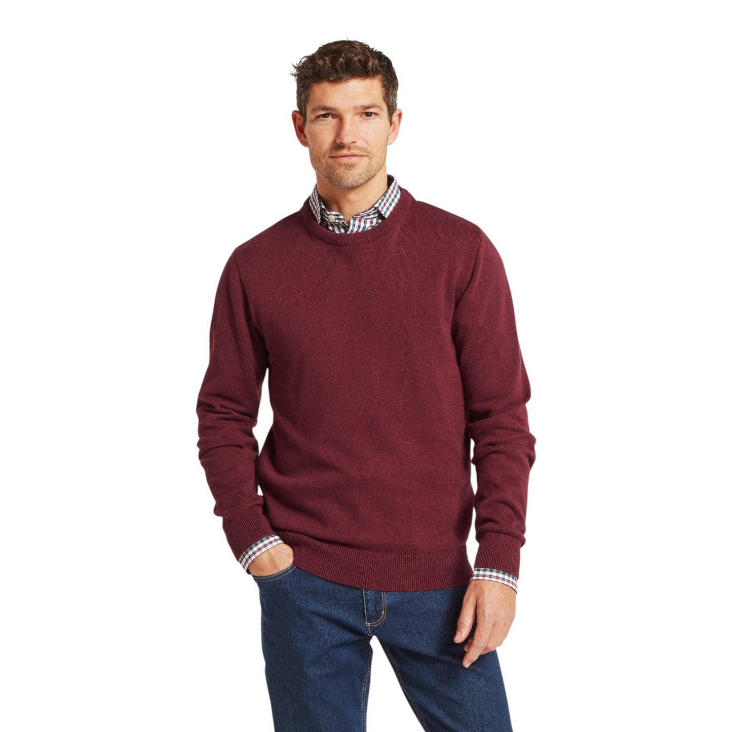 Man wearing a burgundy sweater with a checkered shirt underneath on a white background