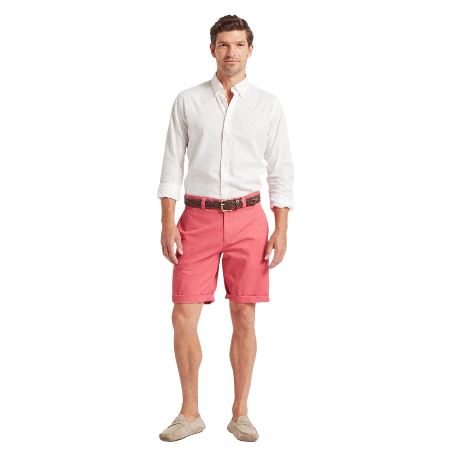 Man wearing a white shirt and pink shorts on a white background
