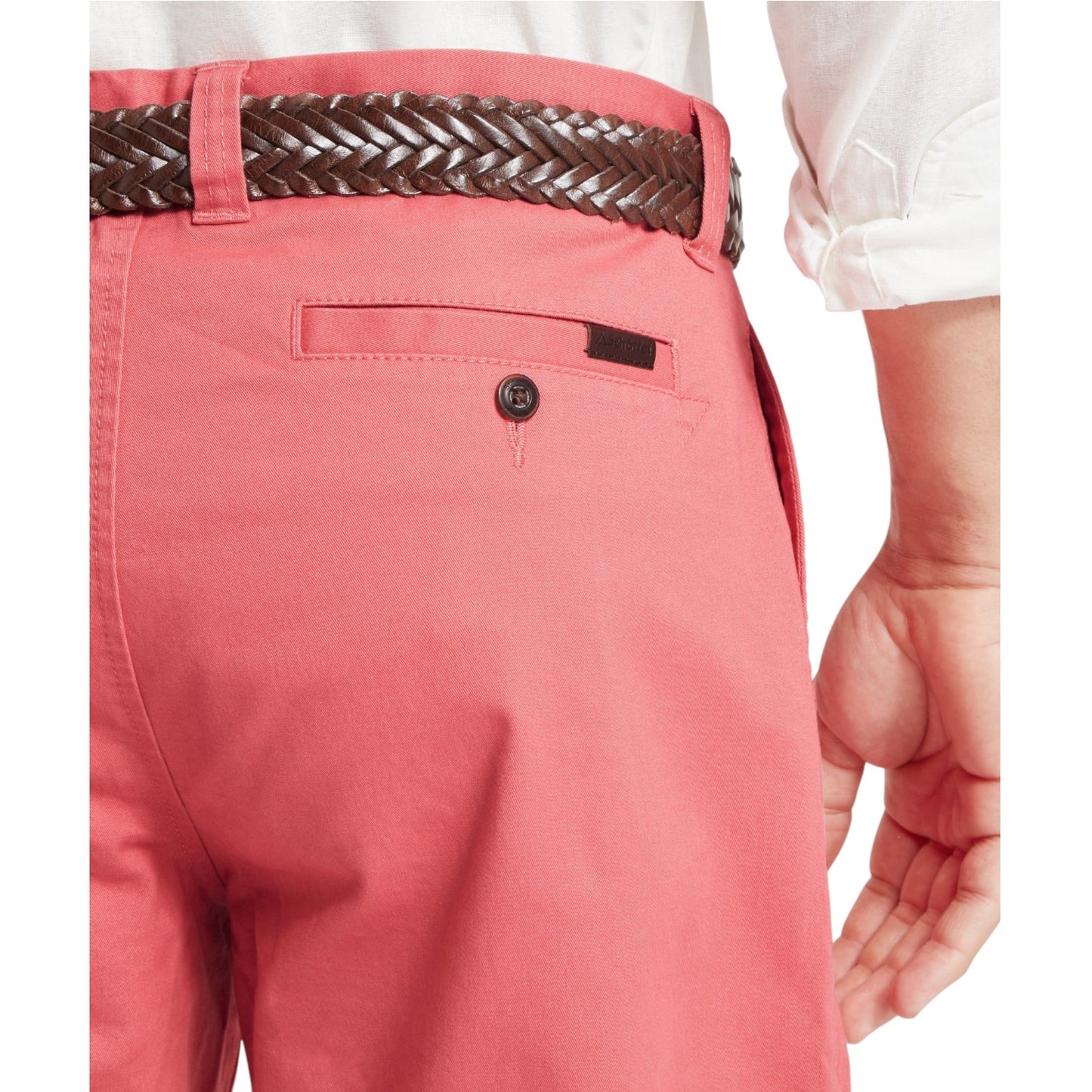 Close-up of pink pants with a woven belt and white shirt on a white background