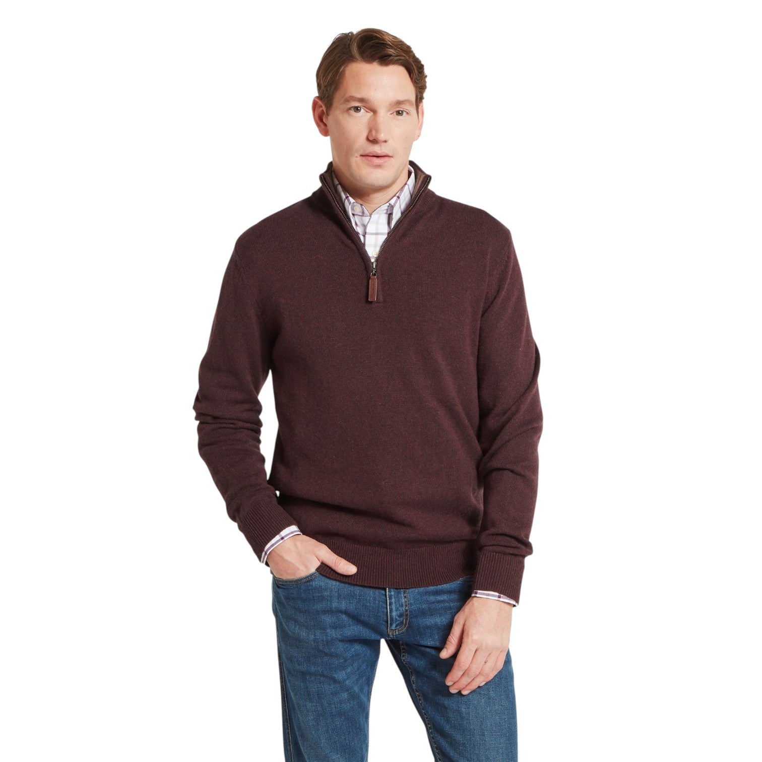 Man wearing a brown sweater and blue jeans on a white background