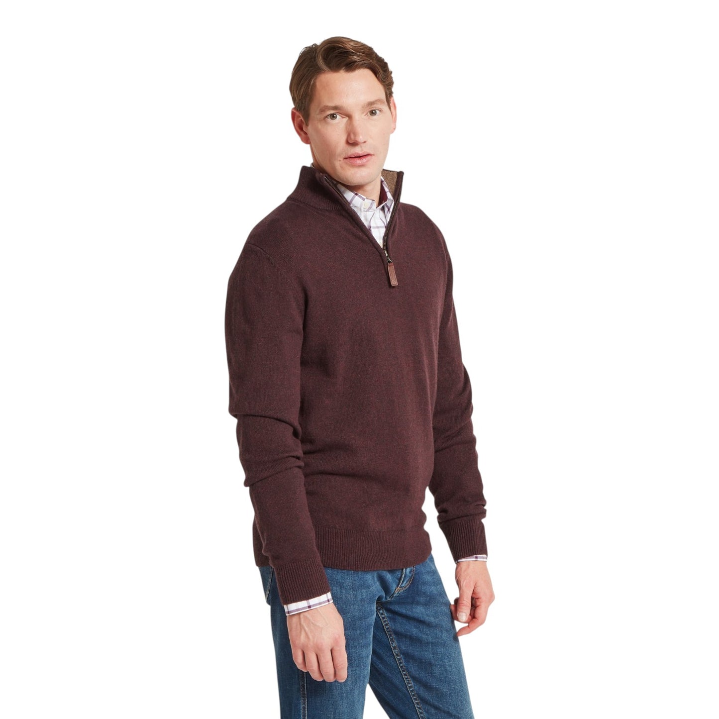 Man wearing a brown sweater and blue jeans on a white background