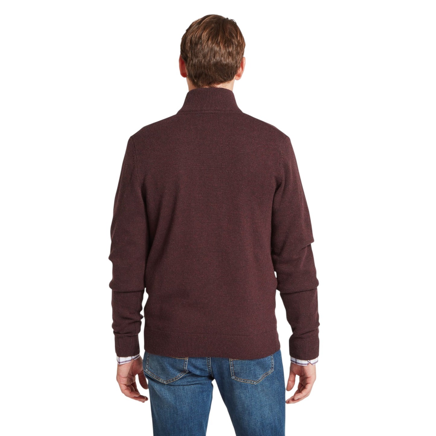 Man wearing a brown sweater and blue jeans on a white background