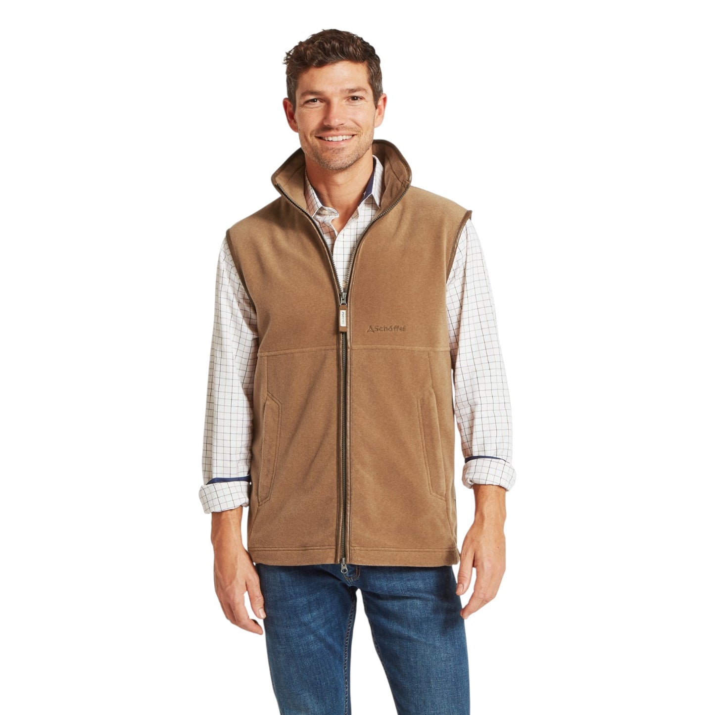 Man wearing a brown vest over a plaid shirt on a white background