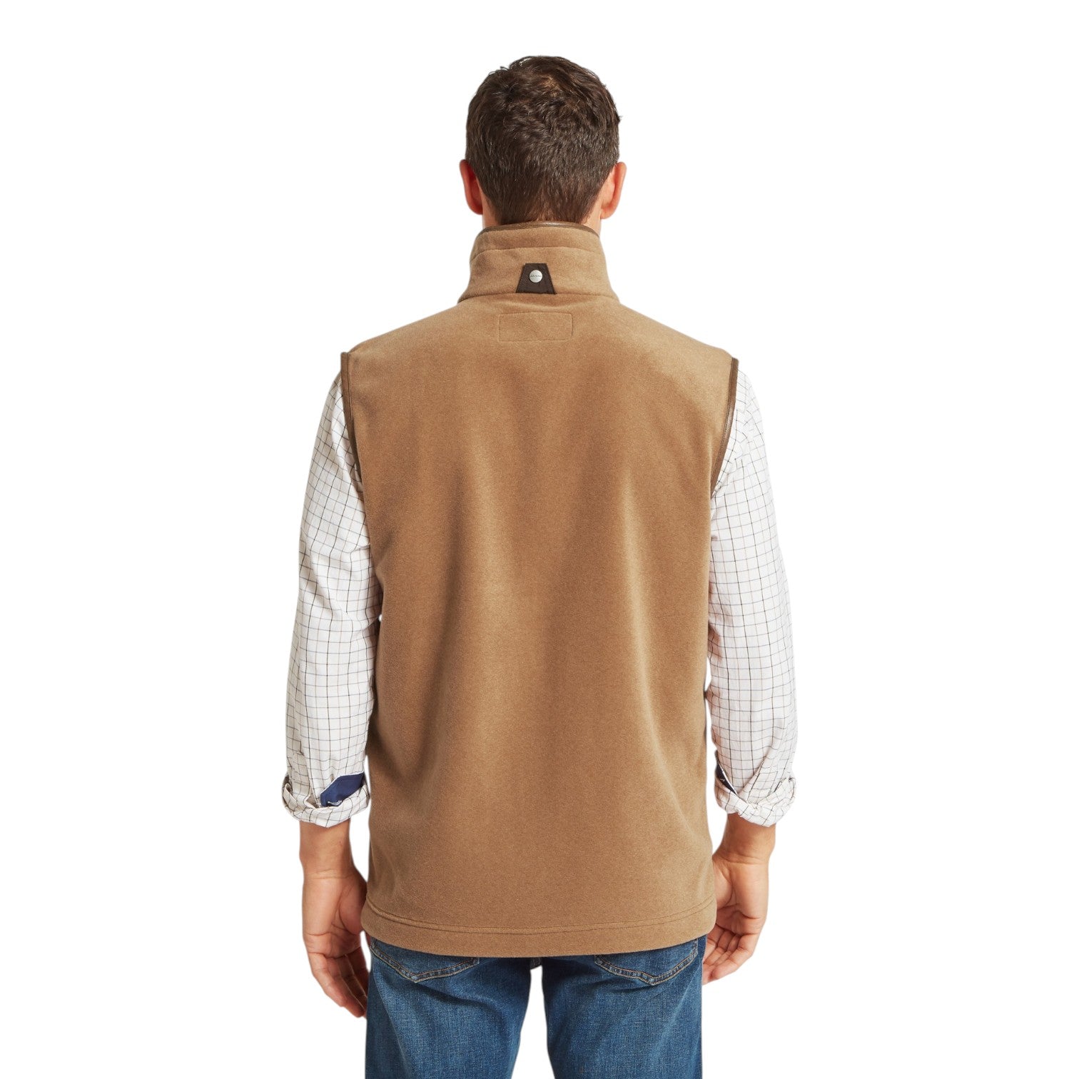 Man wearing a brown vest over a plaid shirt on a white background
