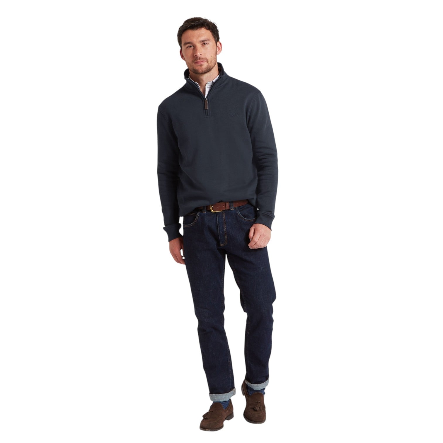 Man wearing a dark blue sweater and jeans on a white background