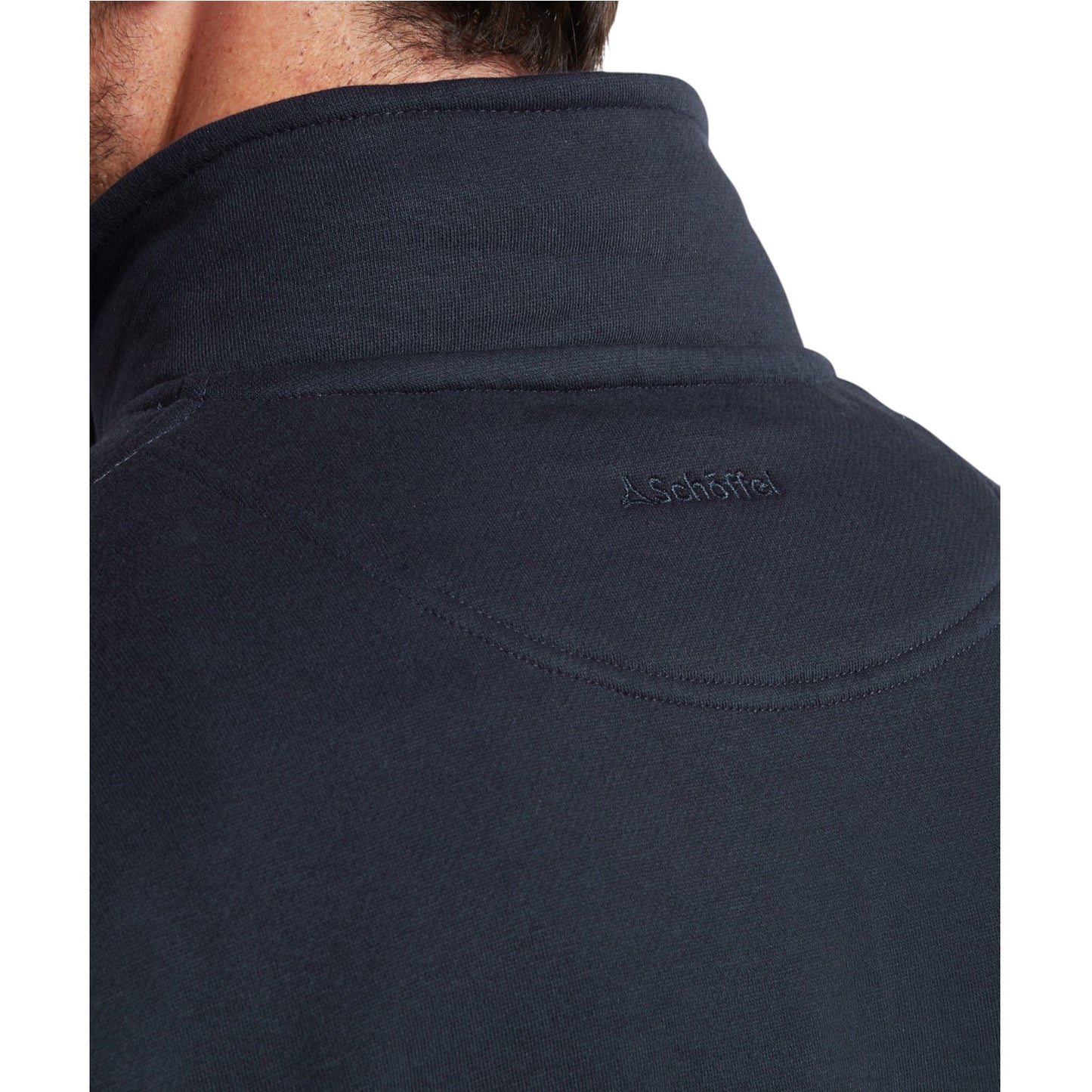 Navy blue jacket with a brand logo on the shoulder against a white background