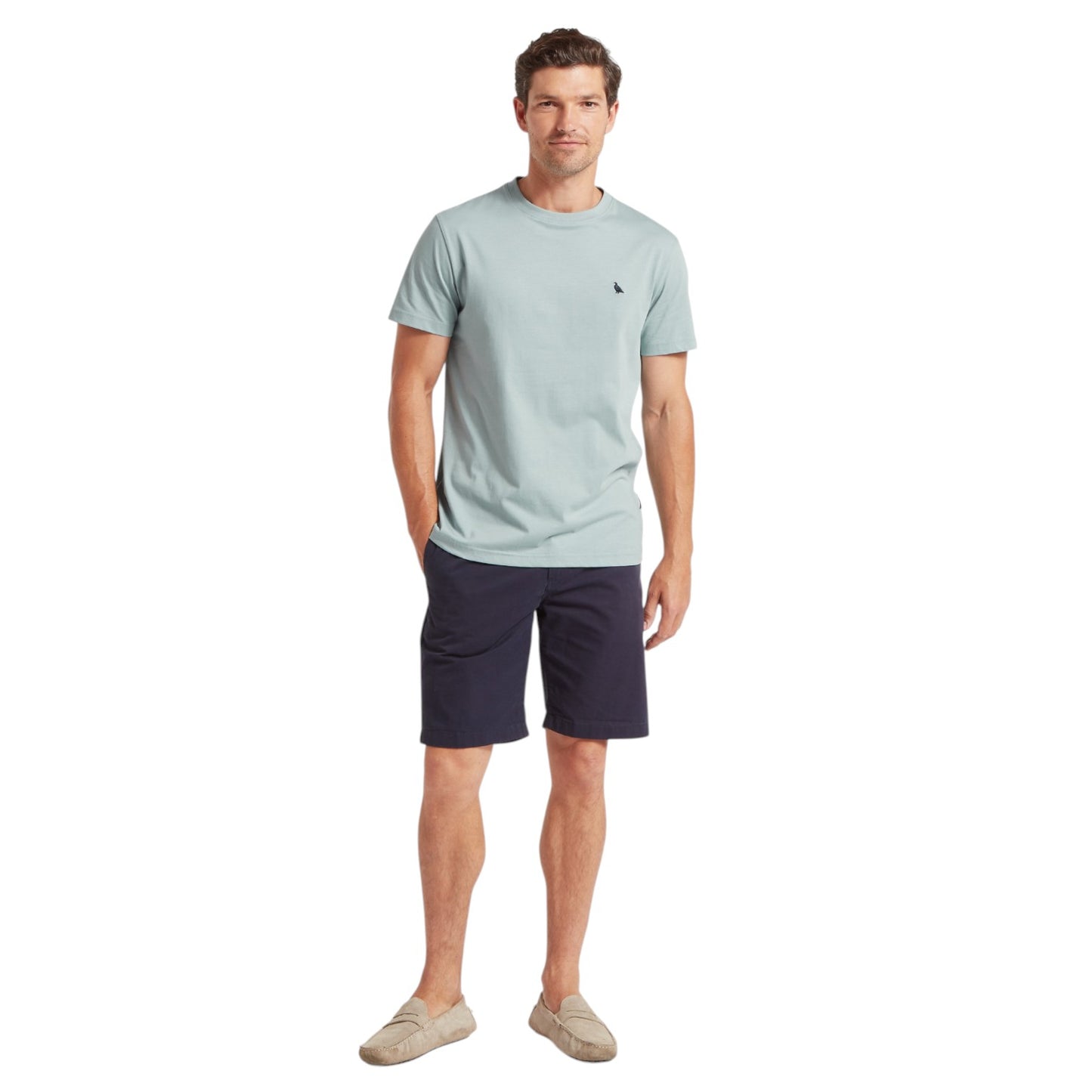 Man wearing a light blue t-shirt and navy shorts on a white background