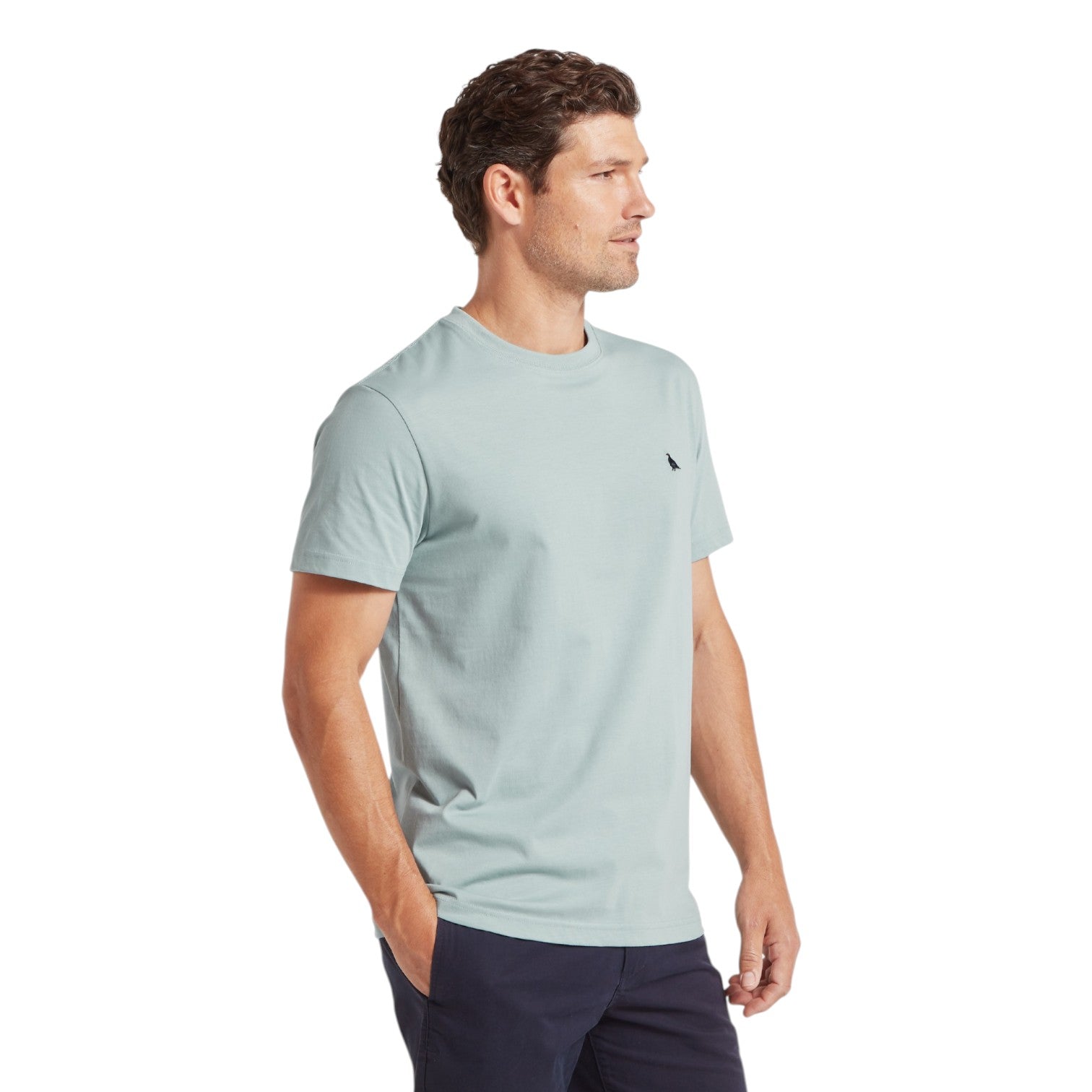 Man wearing a light blue t-shirt on a white background