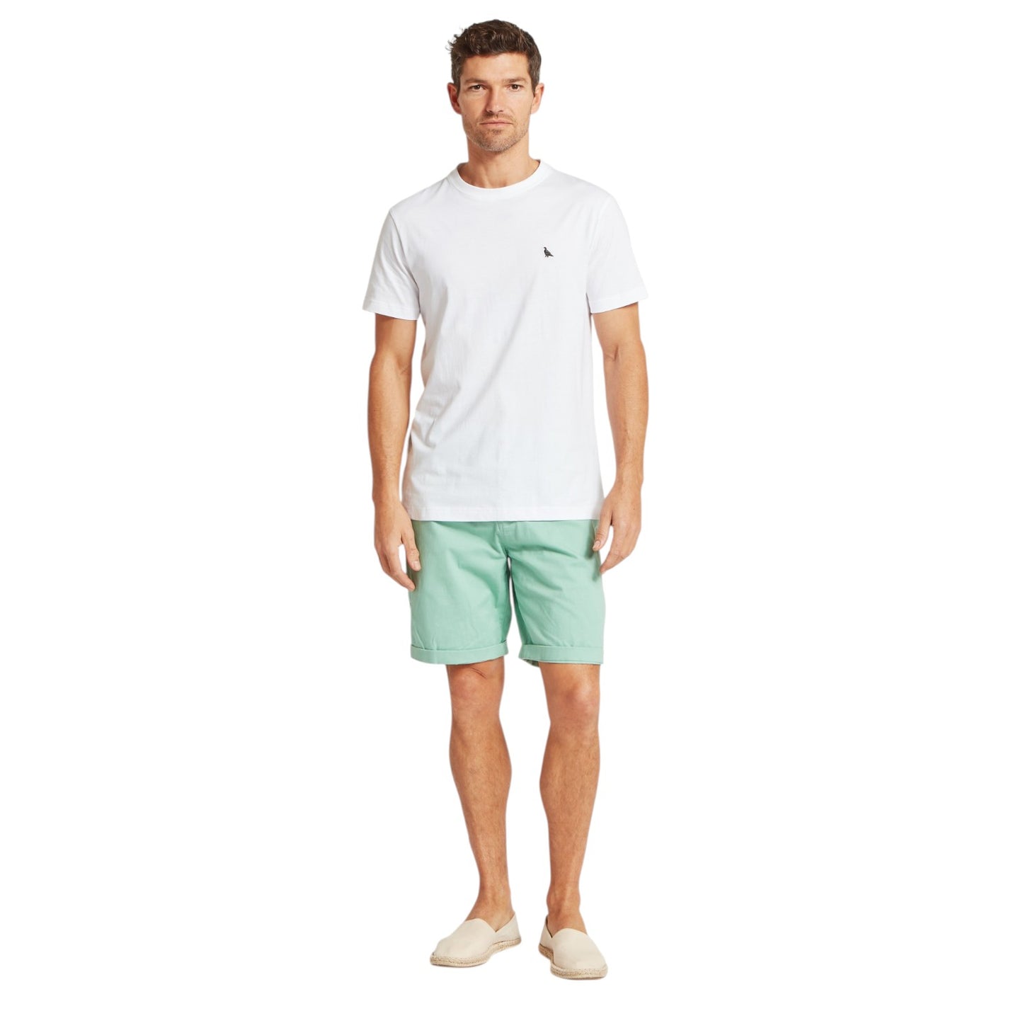 Man wearing a white t-shirt and light green shorts on a white background