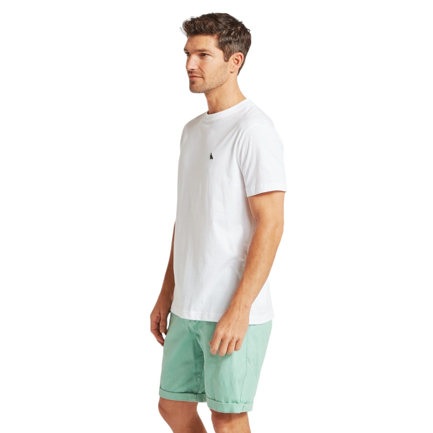 Man wearing a white t-shirt and light green shorts on a white background