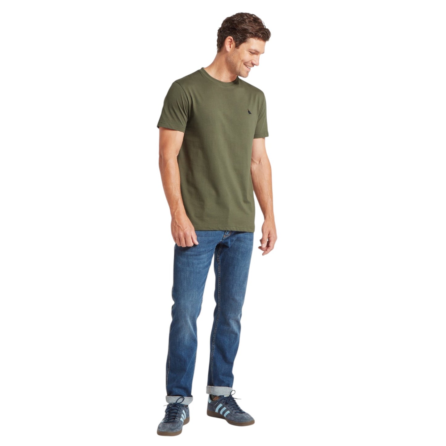 Man wearing a green t-shirt and blue jeans on a white background
