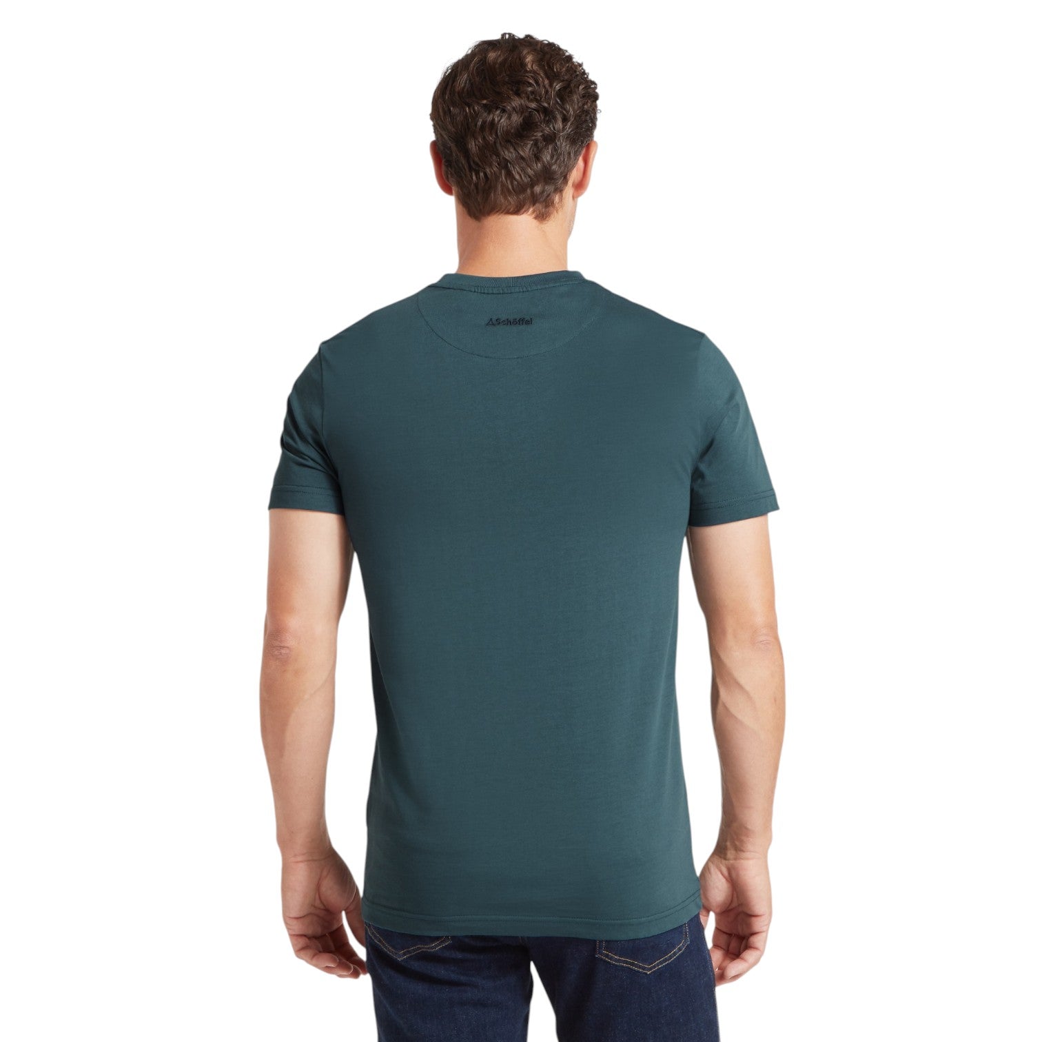 Man wearing a teal t-shirt with a brand logo on the back, standing against a white background