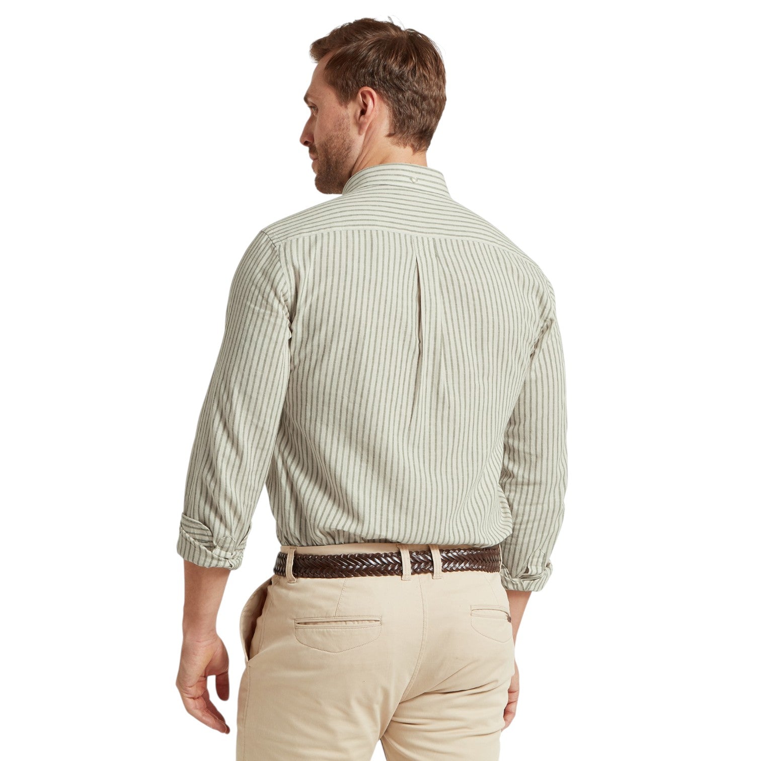 Man wearing a green striped shirt and beige pants on a white background