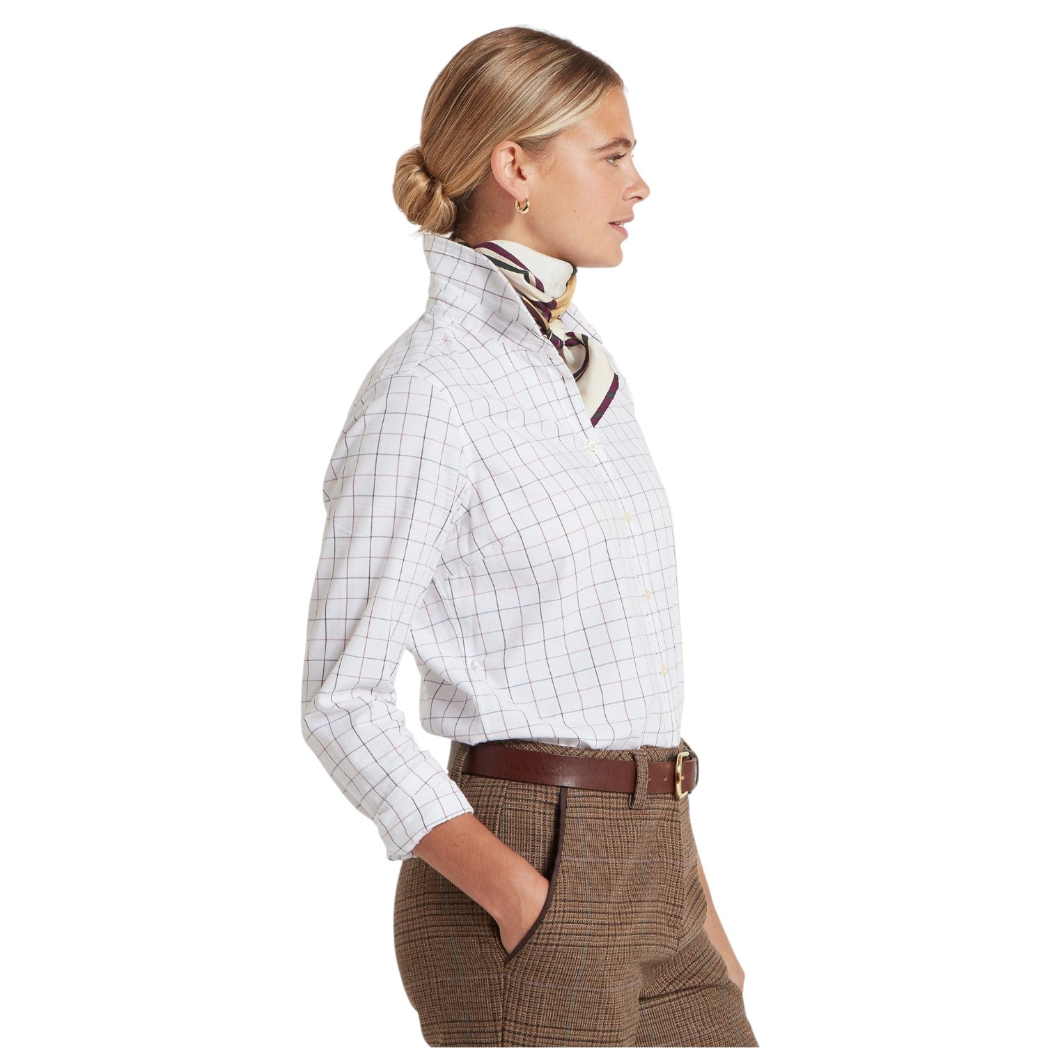 Woman wearing a white checkered shirt and brown pants on a white background