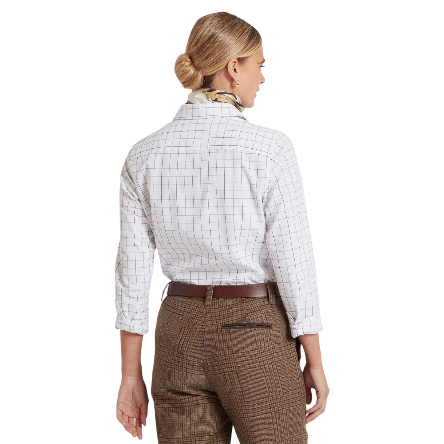 Woman wearing a white checkered shirt and brown plaid pants on a white background