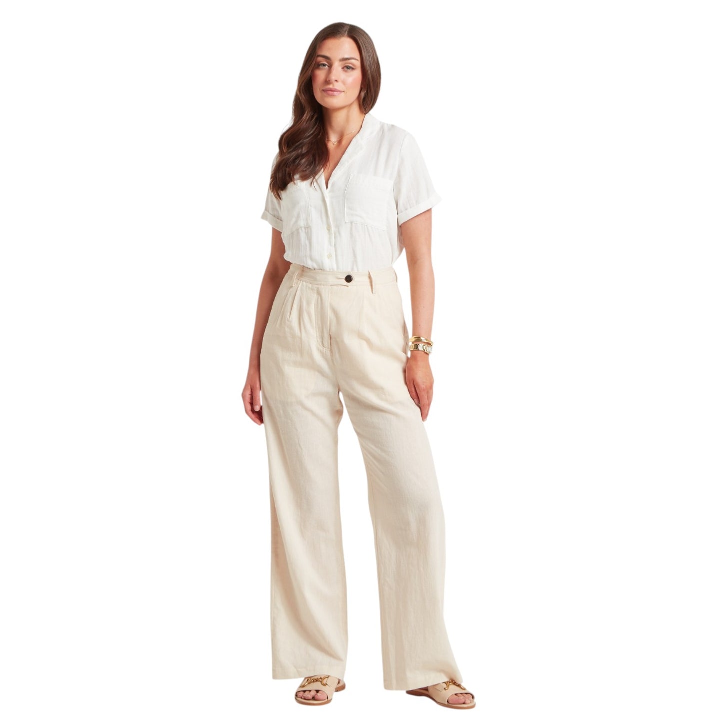 Woman wearing a white blouse and beige pants on a white background