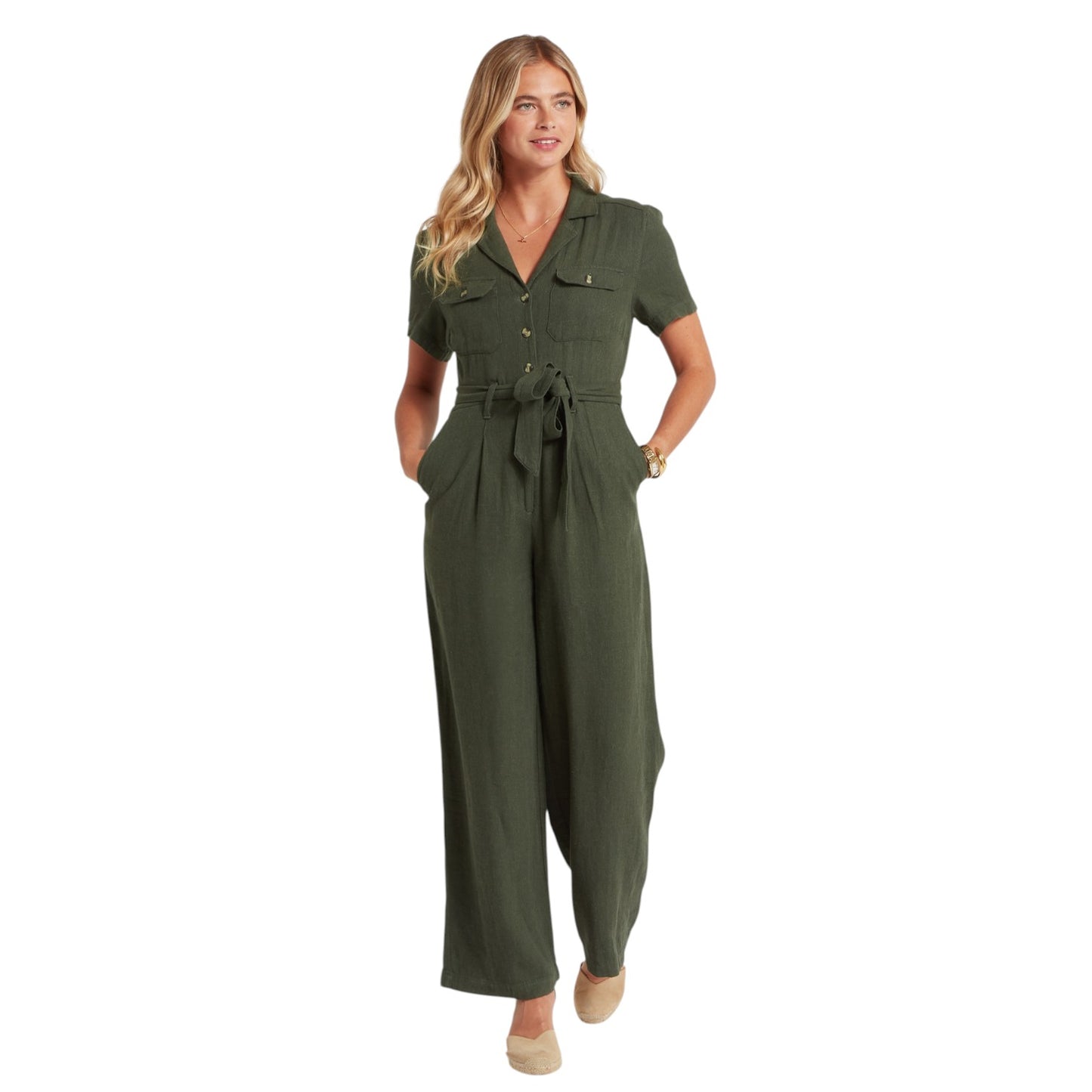 Woman wearing a green jumpsuit on a white background
