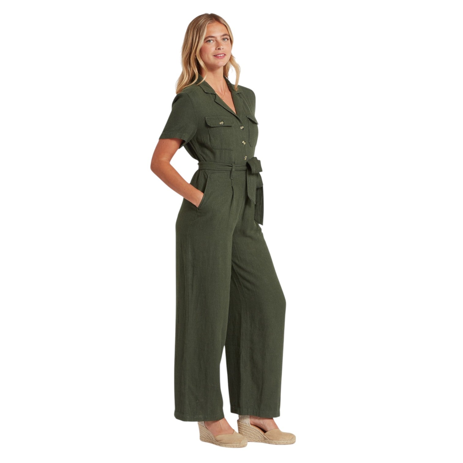 Woman wearing a green jumpsuit on a white background