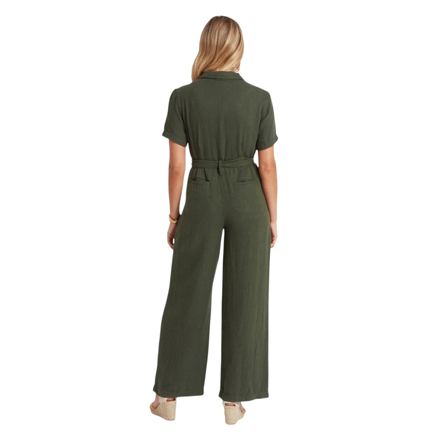 Woman wearing a green jumpsuit on a white background