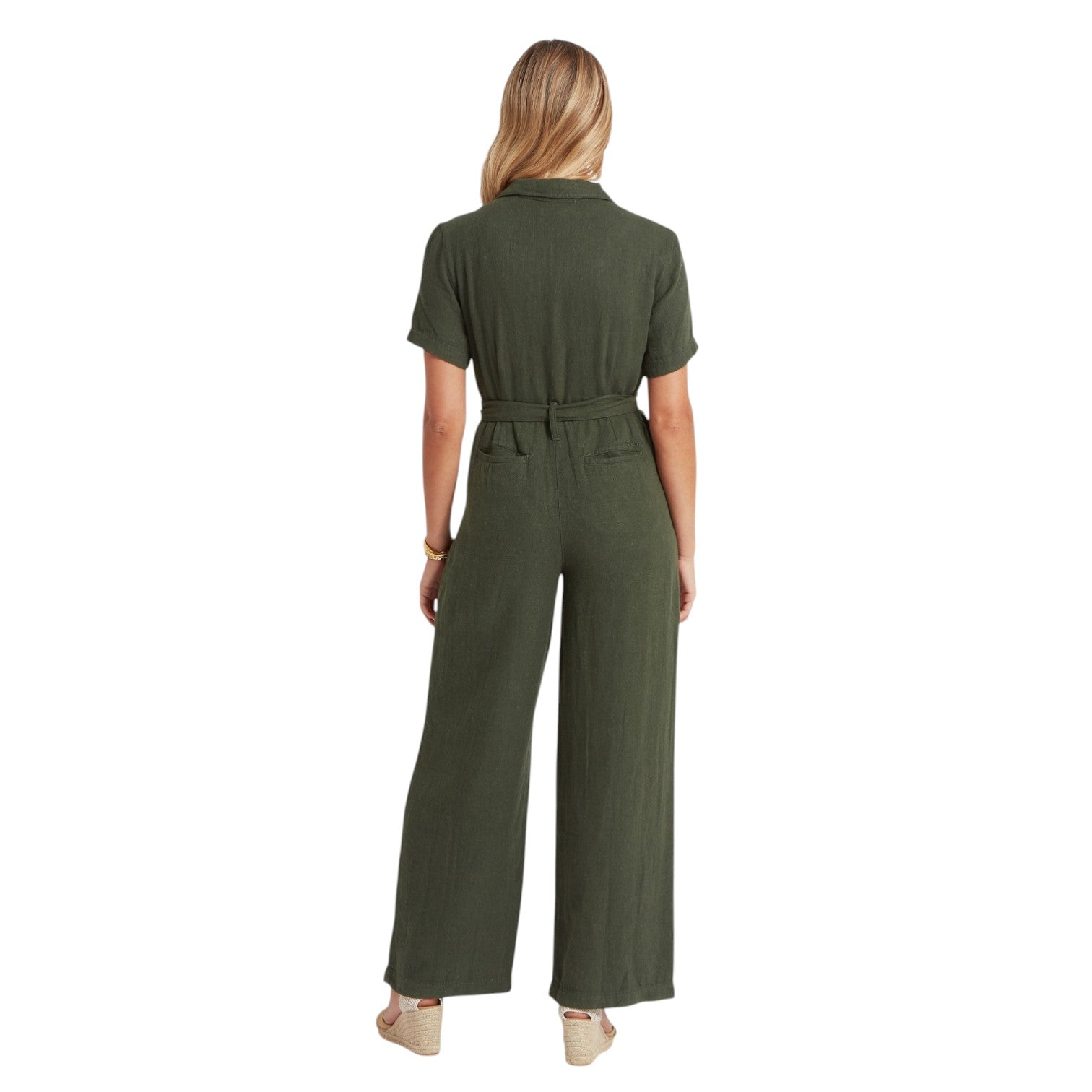 Woman wearing a green jumpsuit on a white background