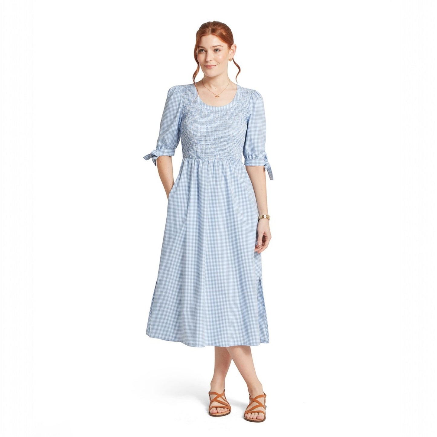 Woman wearing a light blue checkered dress on a white background