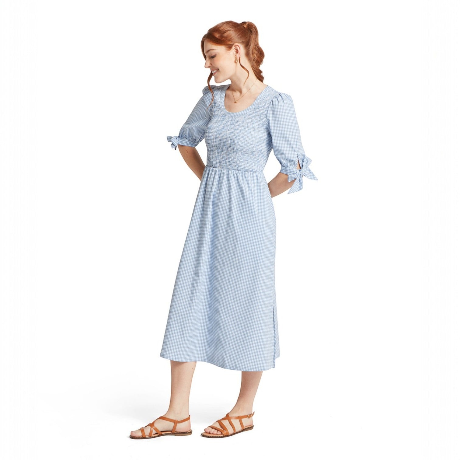 Woman wearing a light blue checkered dress on a white background