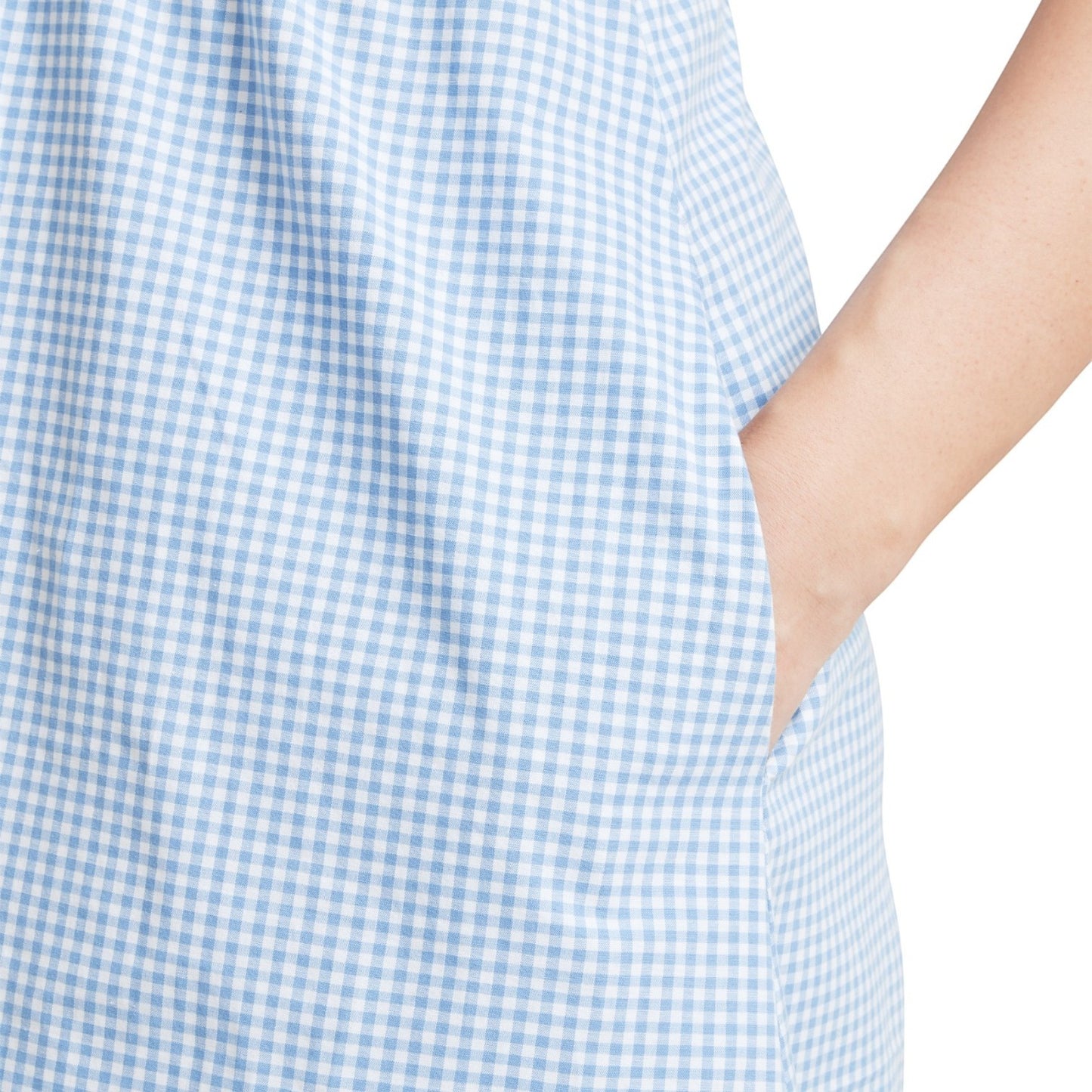 Close-up of a blue and white checkered dress with a blurred background