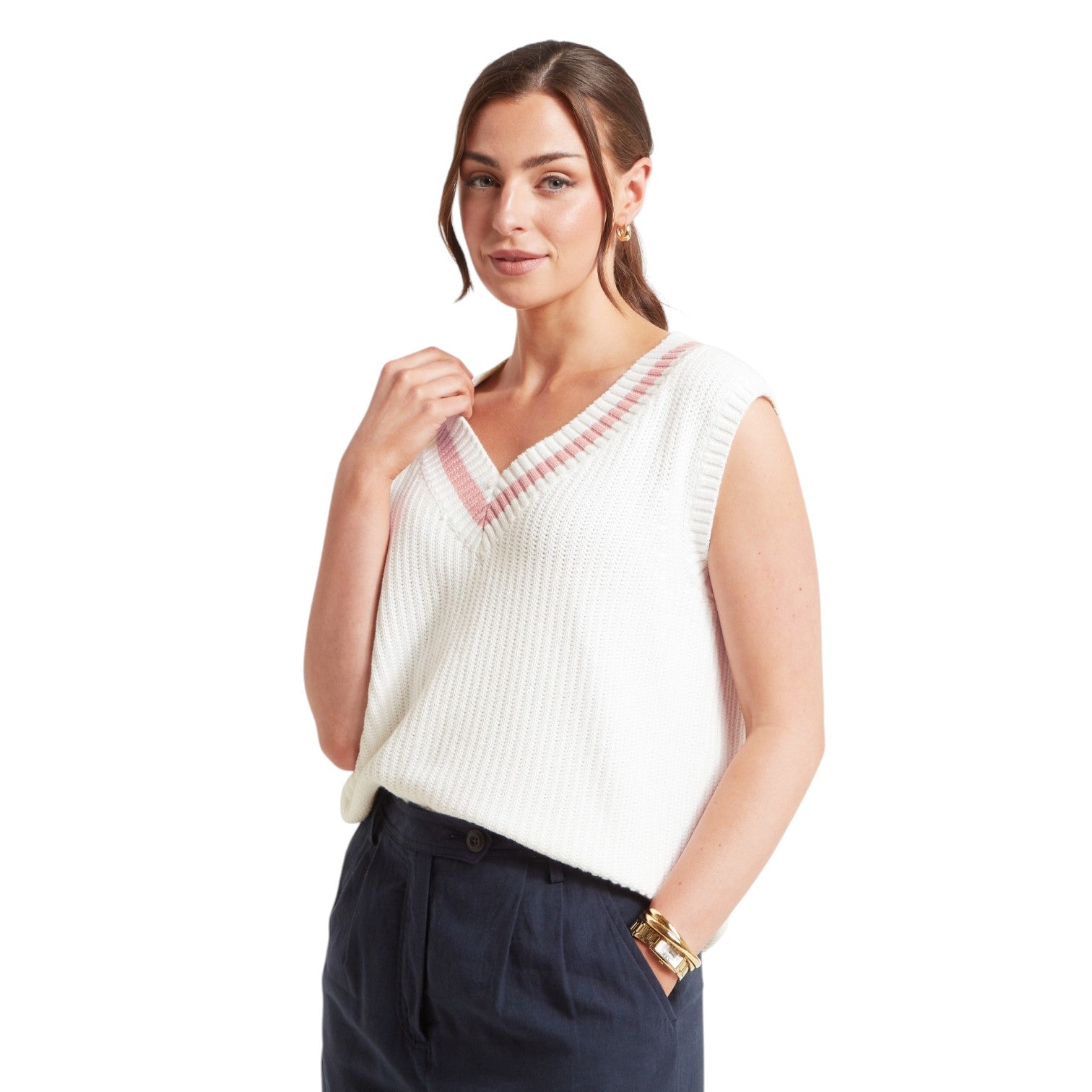 Woman wearing a white sleeveless top with red accents on a white background