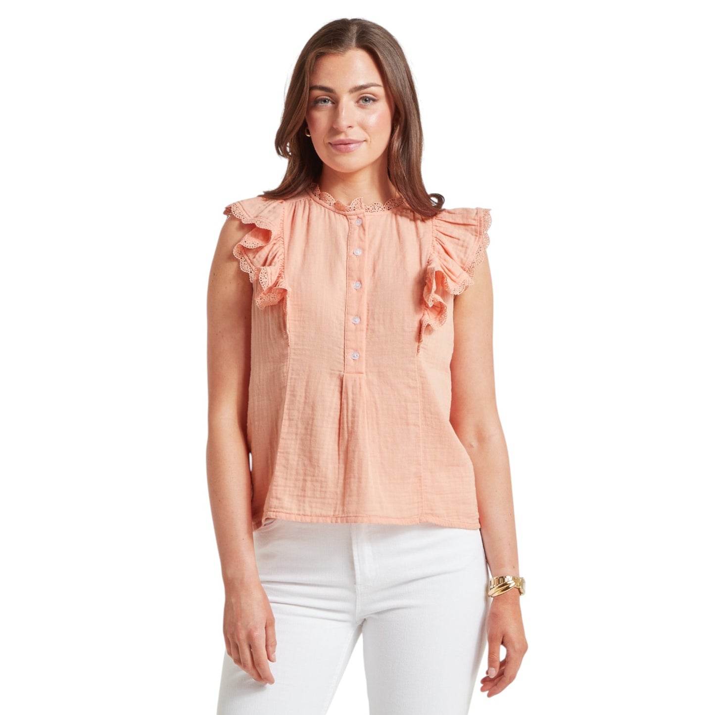 Woman wearing a peach blouse with ruffled sleeves on a white background