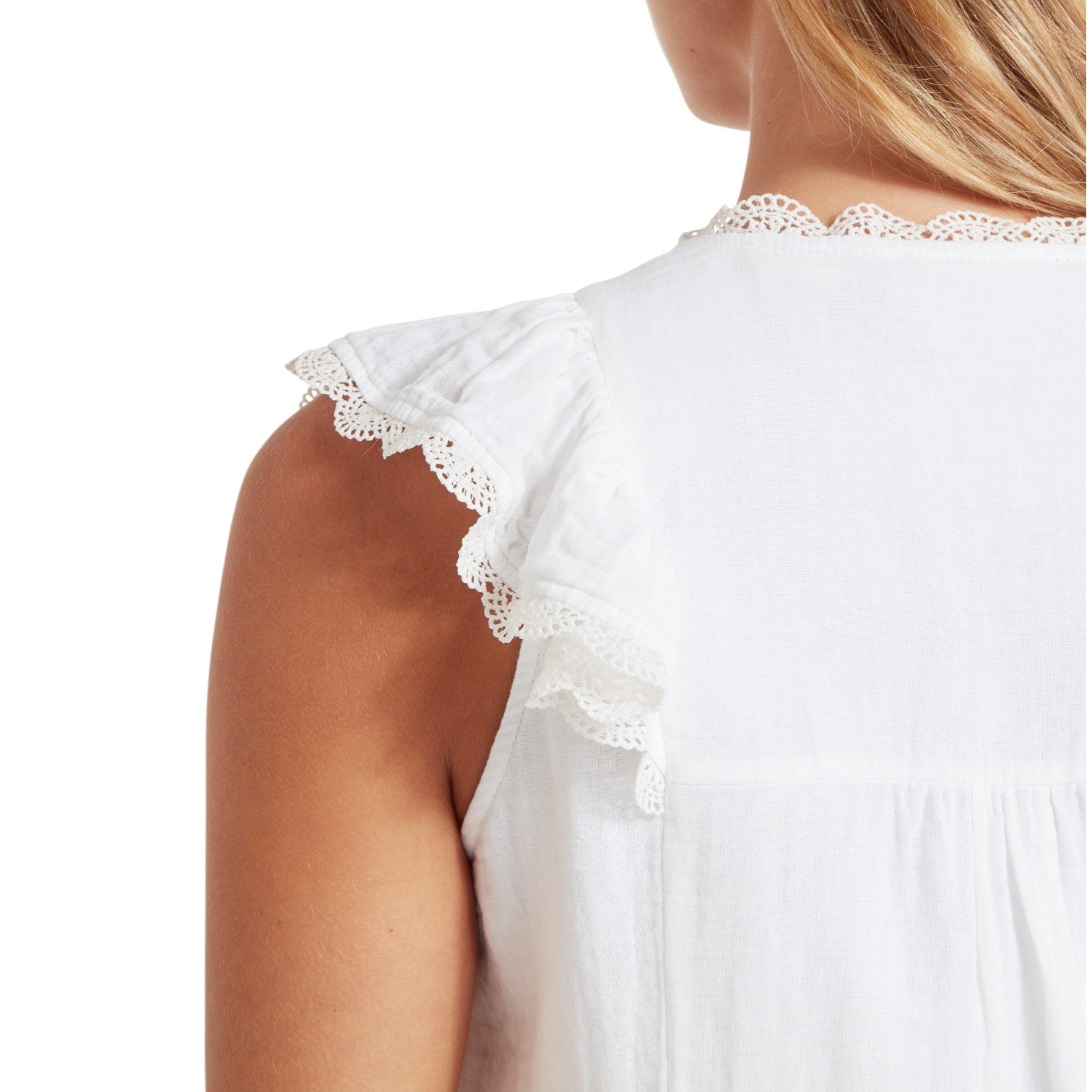 White sleeveless top with lace details on a white background