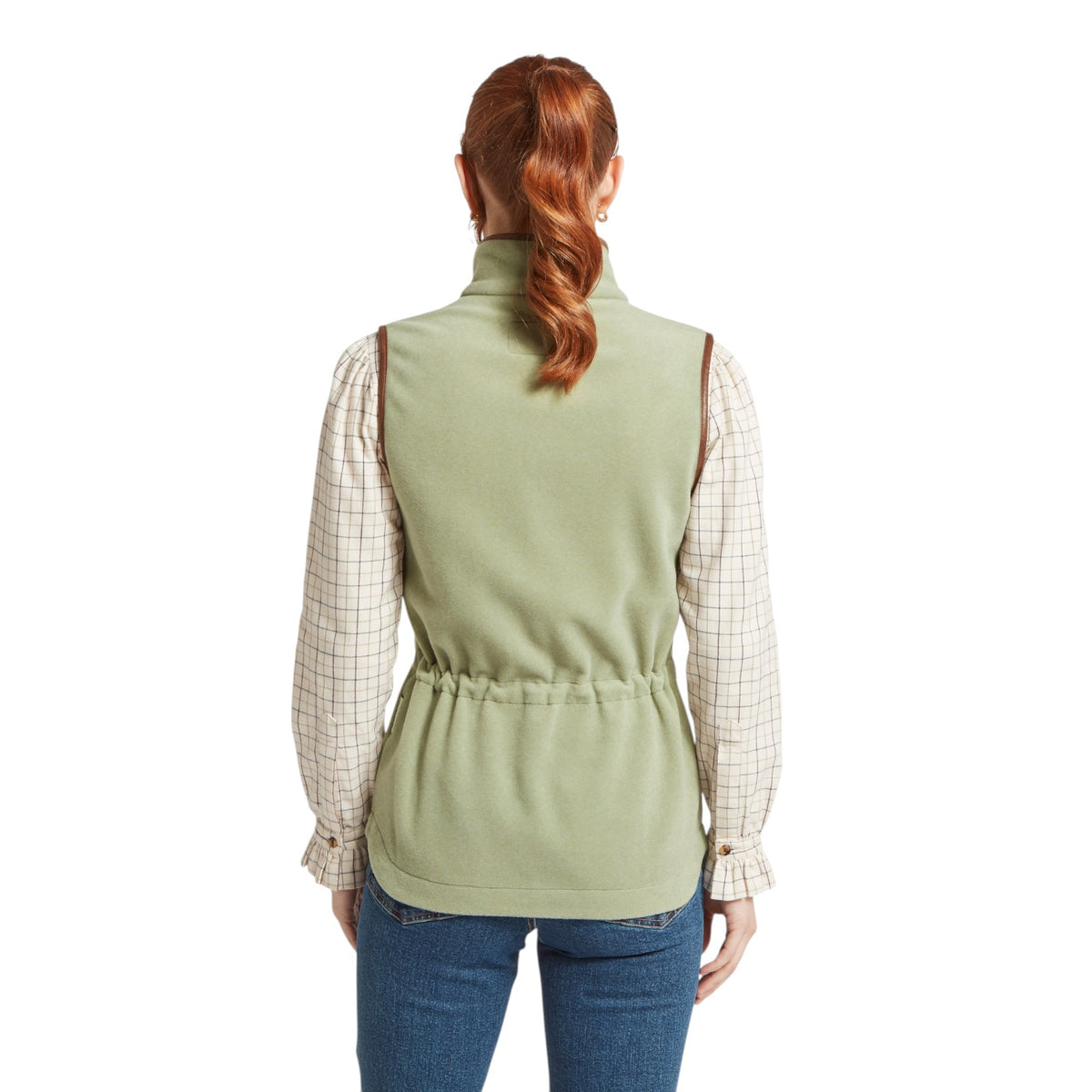 Person wearing a green vest over a plaid shirt on a white background