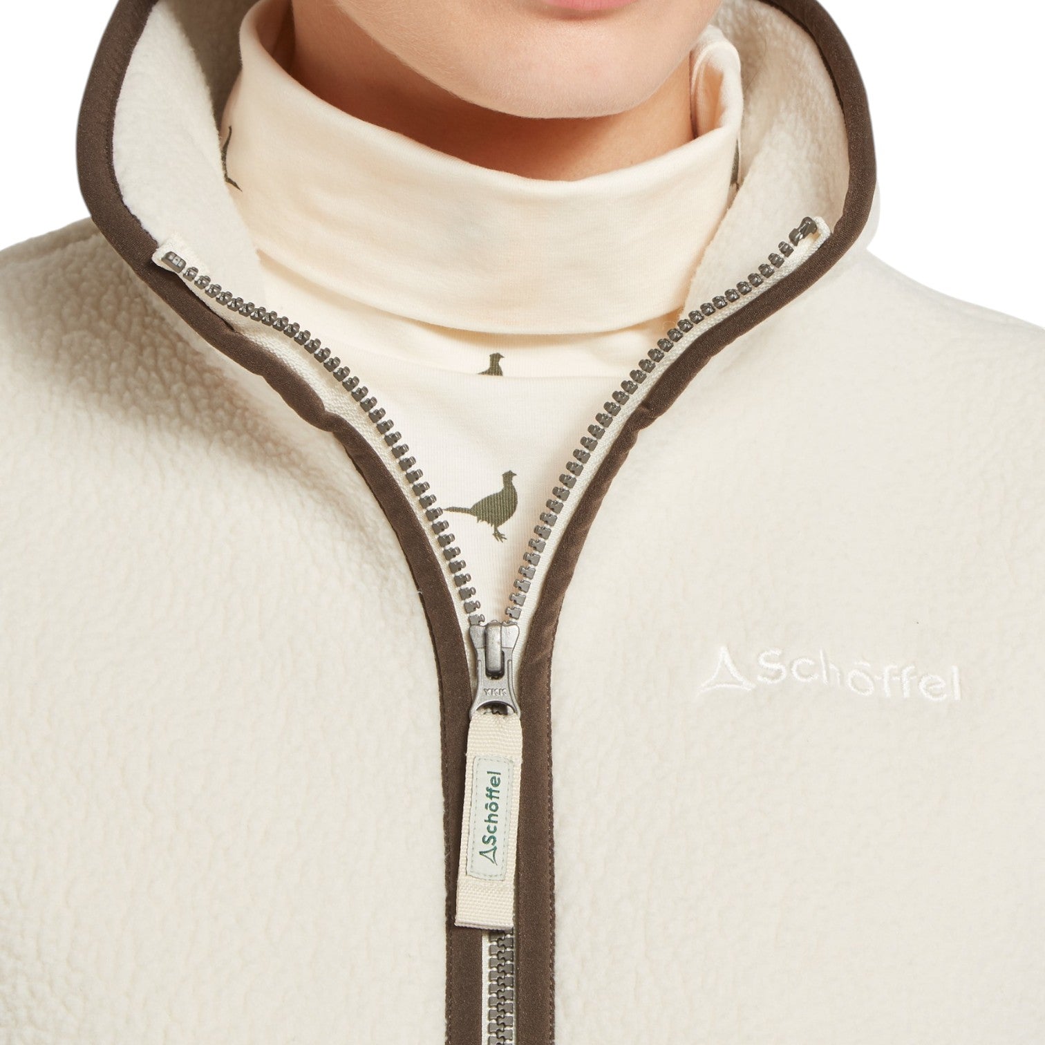 Close-up of a beige fleece jacket with a zipper and brand logo on a white background