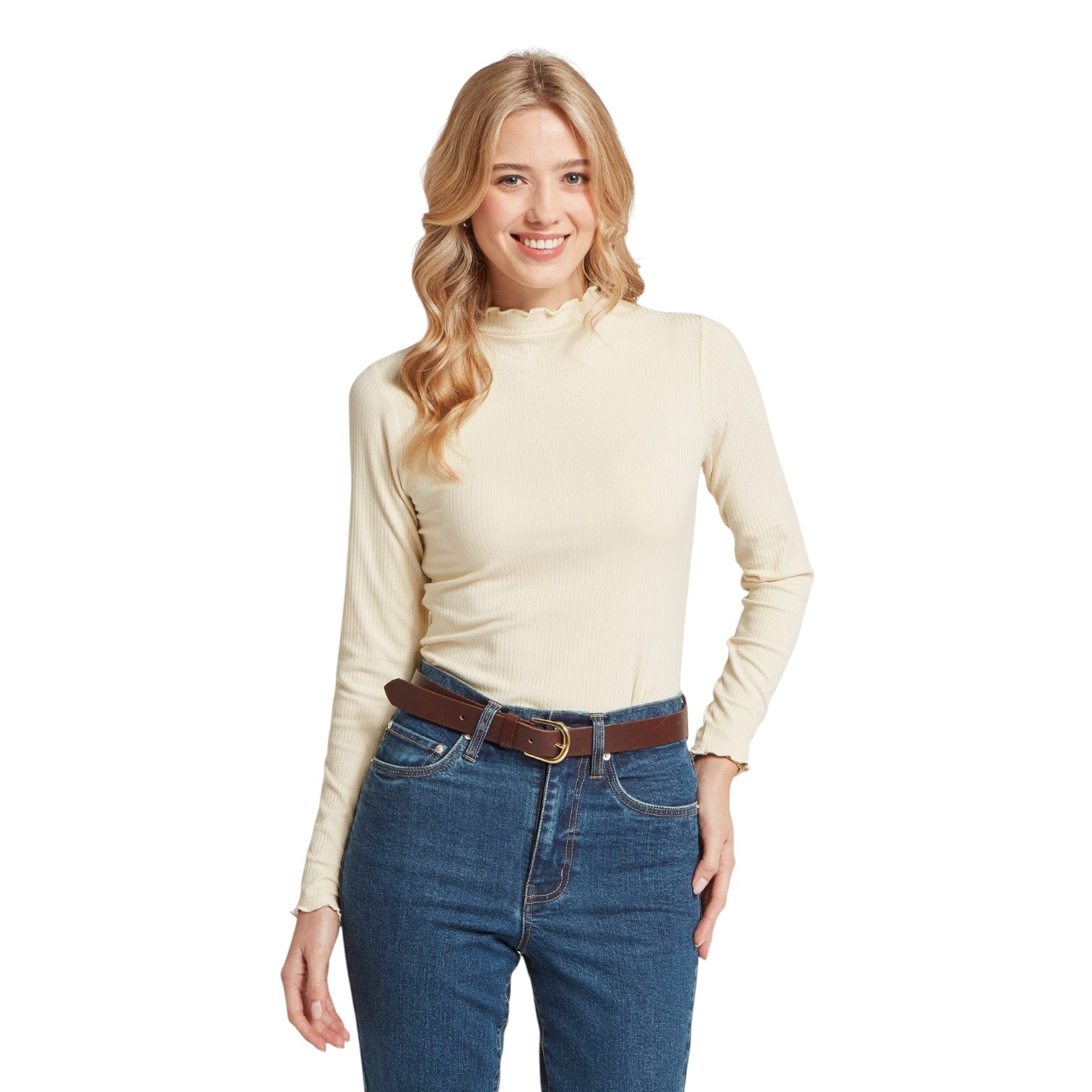 Woman wearing a beige long-sleeve top and blue jeans on a white background
