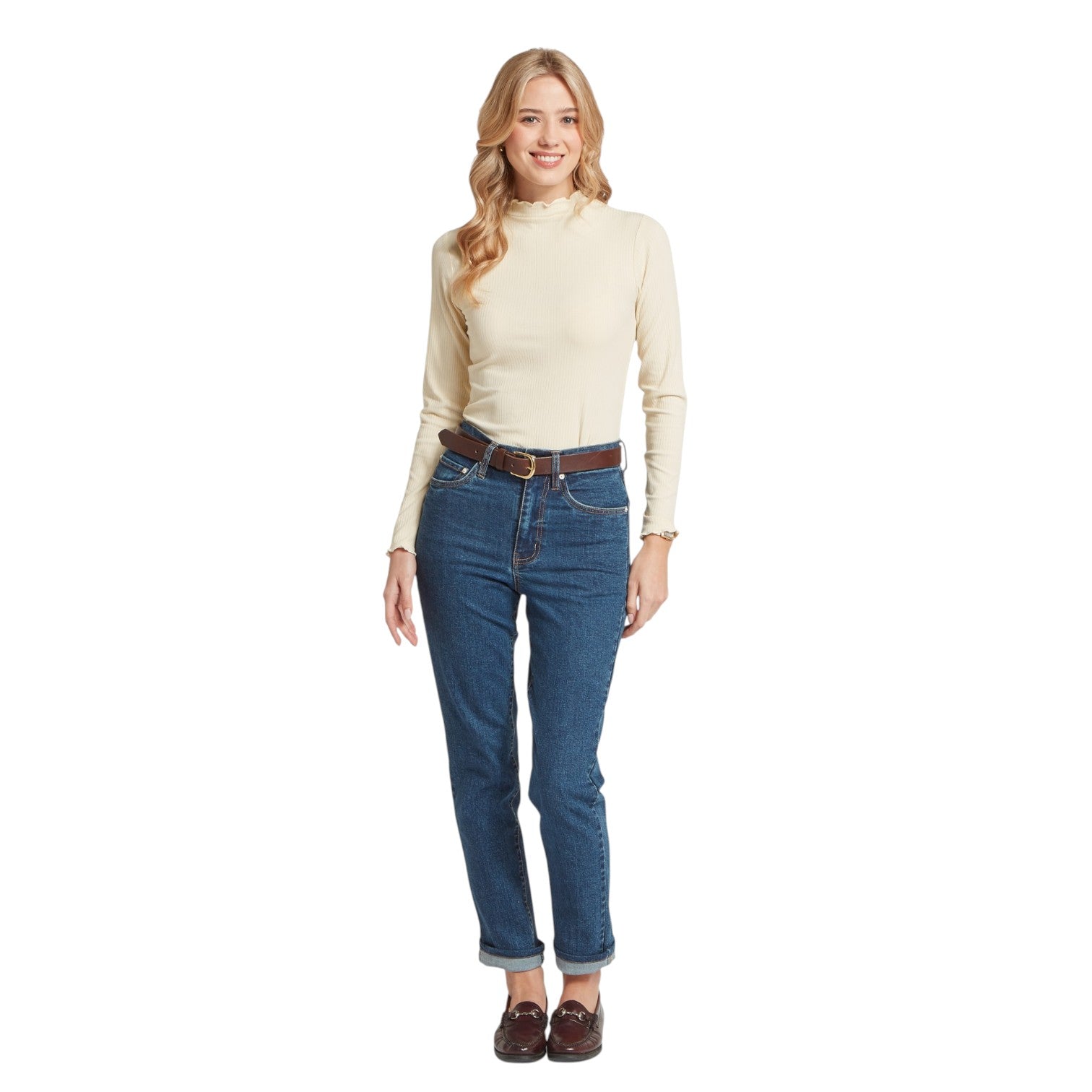 Woman wearing a beige turtleneck and blue jeans on a white background