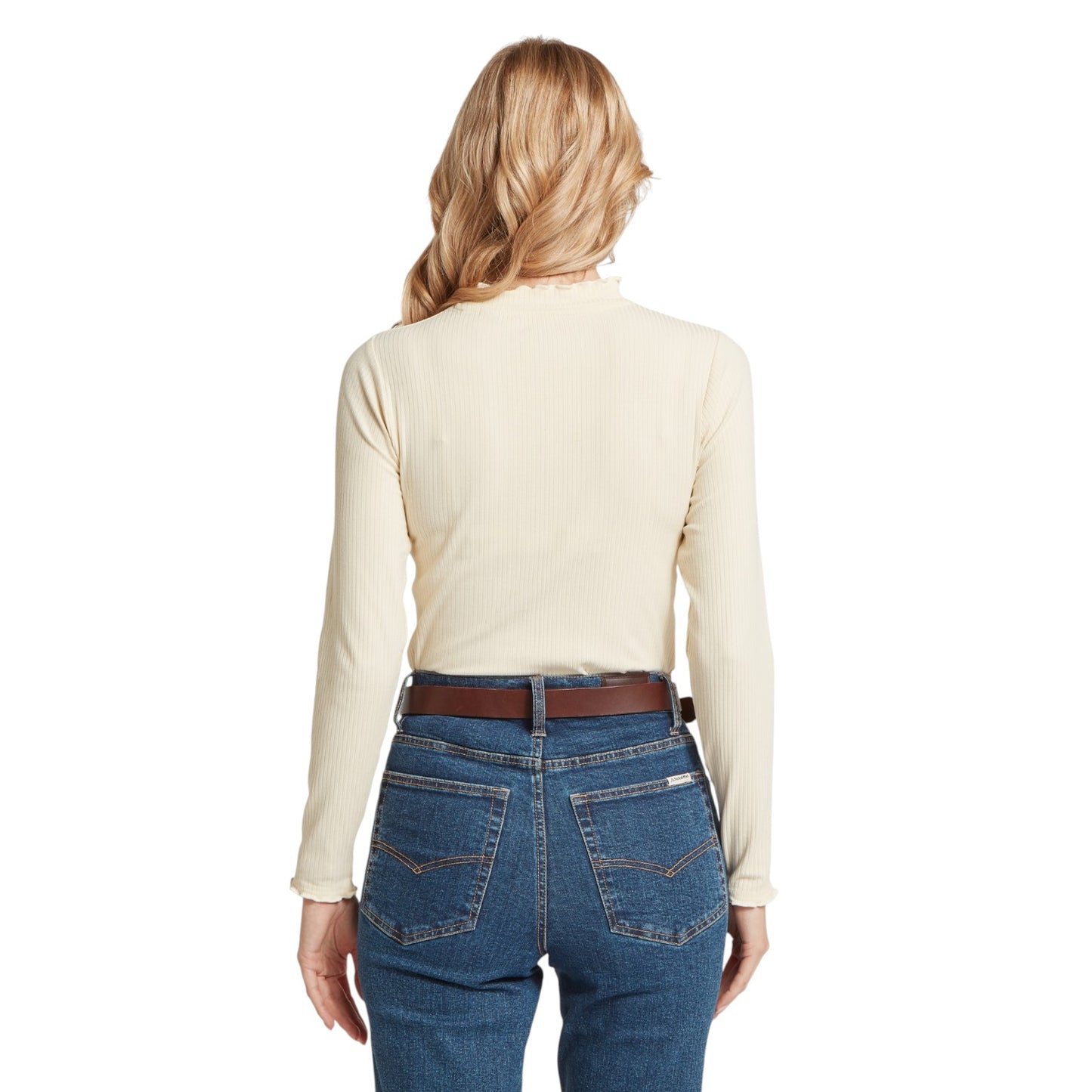Person wearing a beige long-sleeve shirt and blue jeans on a white background