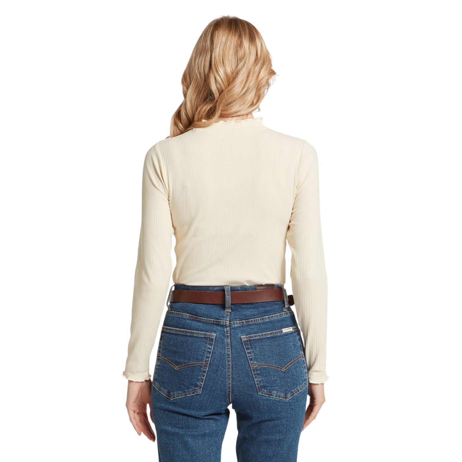 Person wearing a beige long-sleeve shirt and blue jeans on a white background