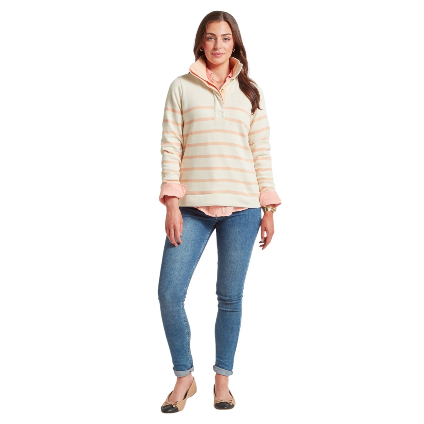 Woman wearing a striped long-sleeve shirt and blue jeans on a white background