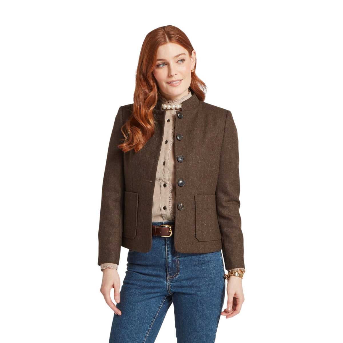 Woman wearing a brown jacket and blue jeans on a white background