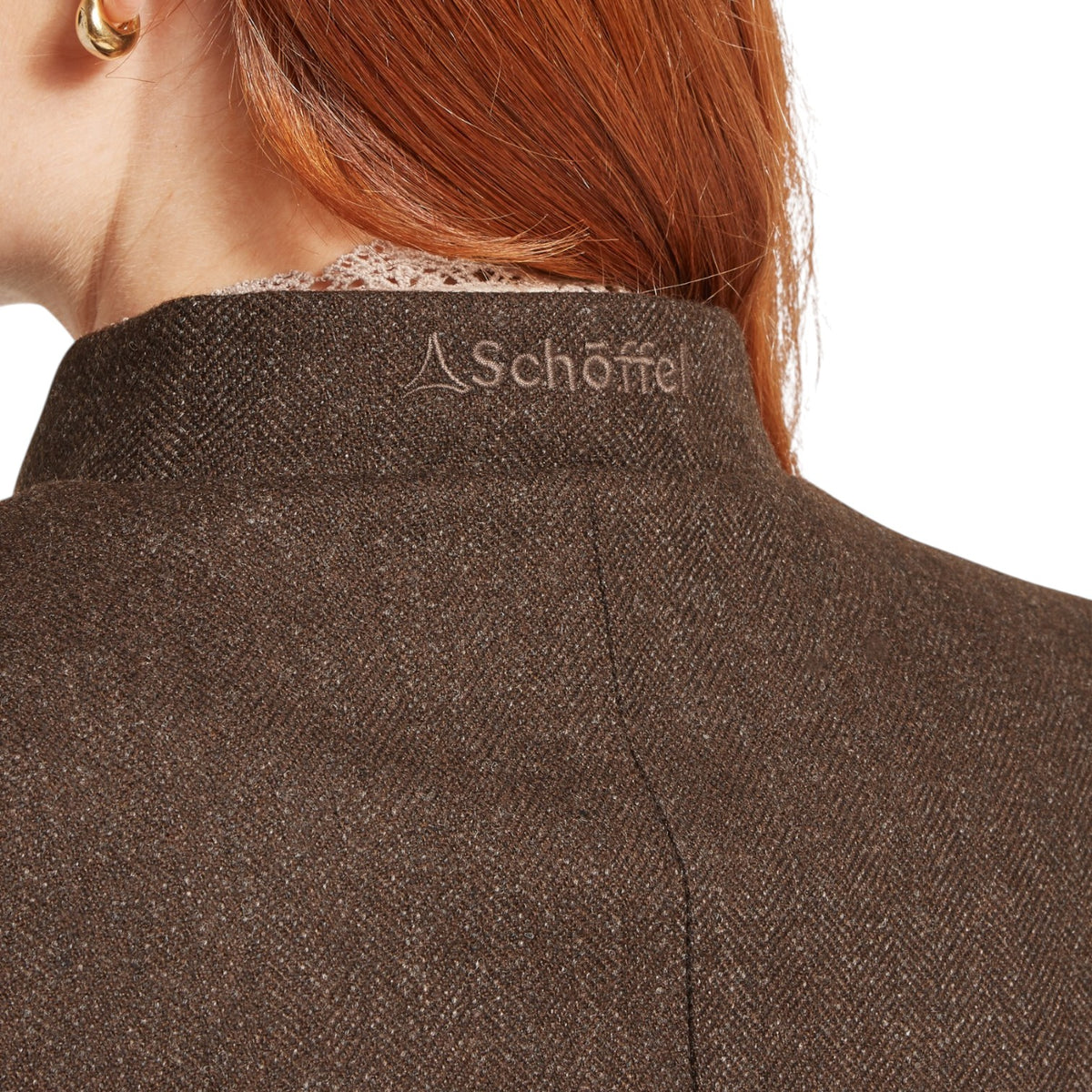 Brown jacket with 'Schoffel' branding on a white background