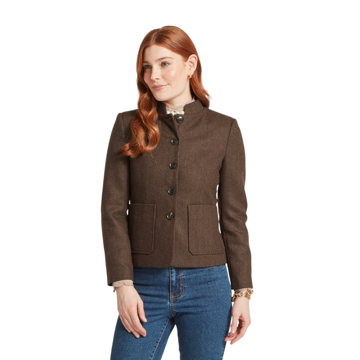 Woman wearing a brown jacket and blue jeans on a white background