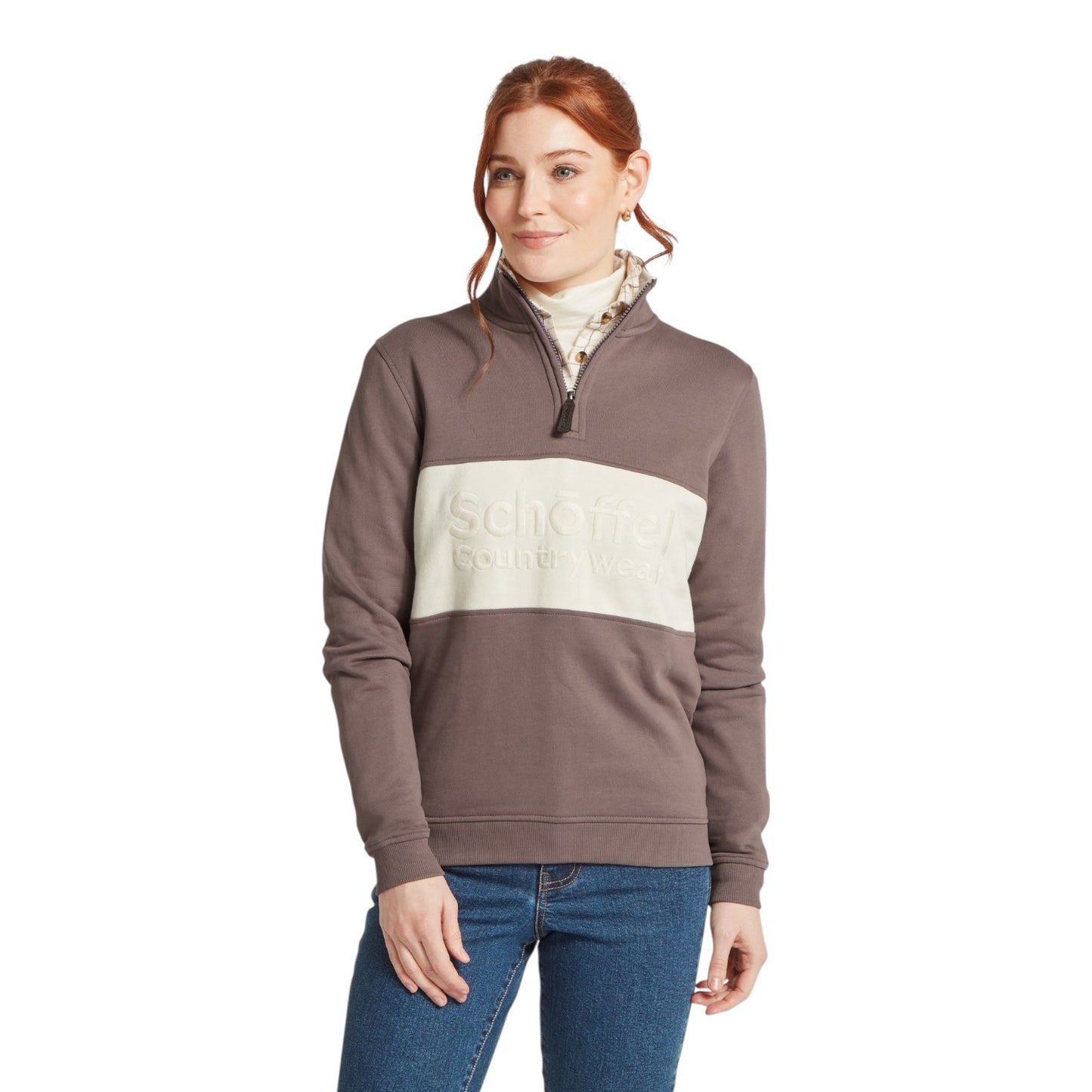 Woman wearing a brown and beige color-blocked pullover with a visible brand logo on a white background